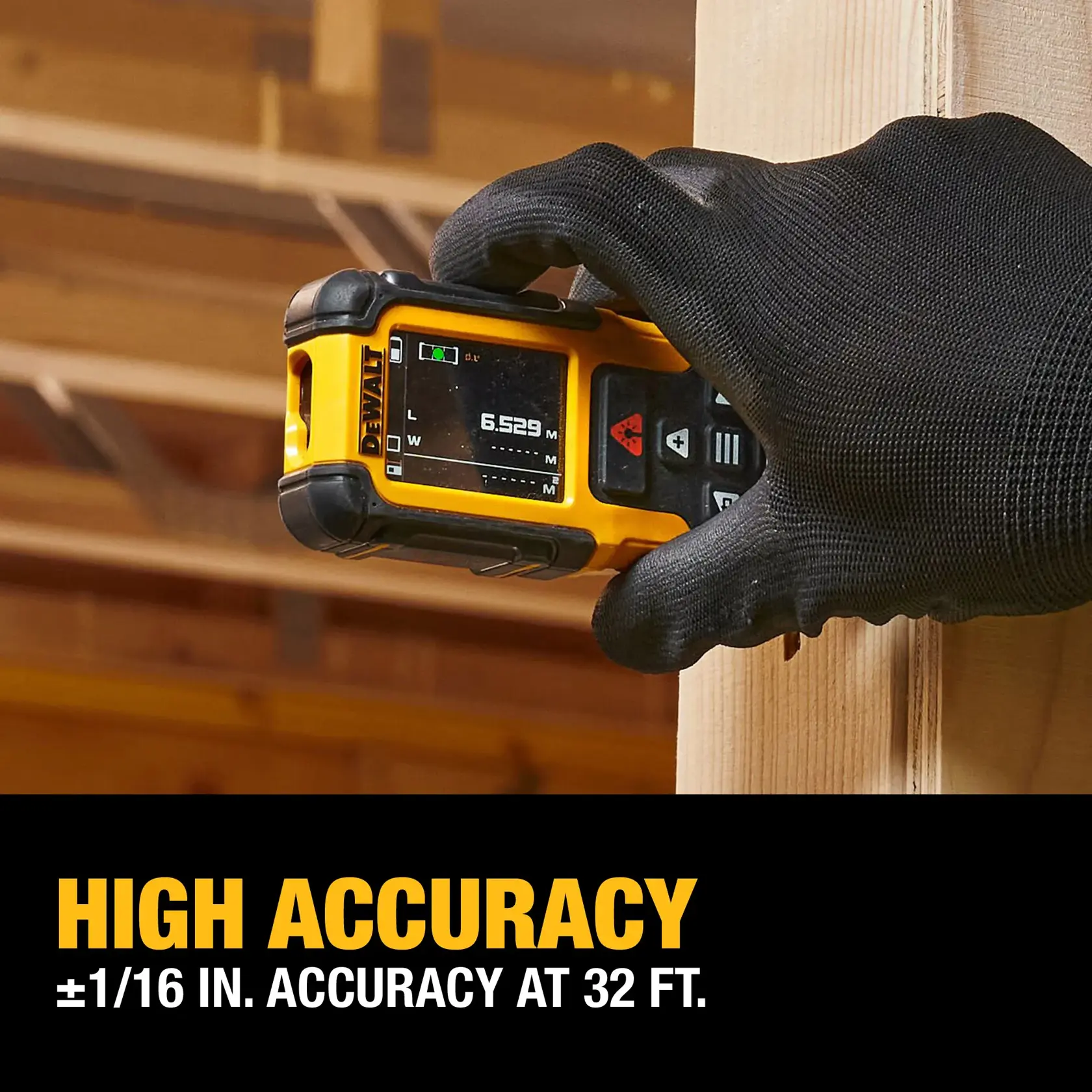 A gloved hand holds a DEWALT laser distance measurer against a wooden beam inside a construction site. The device screen displays a measurement. Text below reads 'HIGH ACCURACY ±1/16 IN. ACCURACY AT 32 FT.'