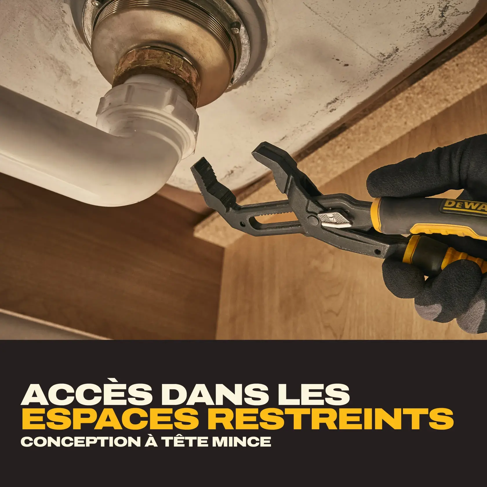 A person wearing gloves is using a DEWALT slim head adjustable pliers to grip a pipe fitting under a sink, demonstrating access in tight areas. The image includes text that highlights the slim head design for working in confined spaces.