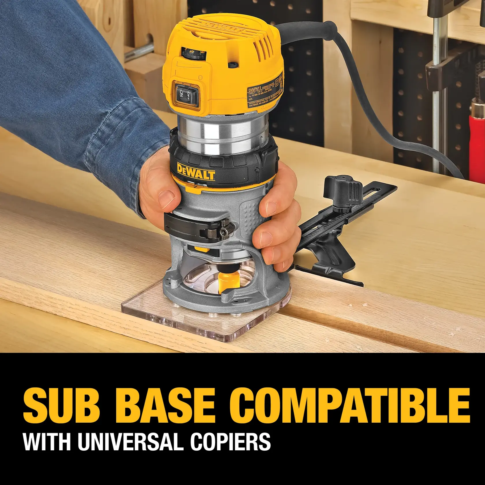 A person using a DEWALT DWP611PK compact router with a clear sub-base, working on a piece of wood in a workshop. The image includes text stating 'Sub Base Compatible with Universal Copiers'.