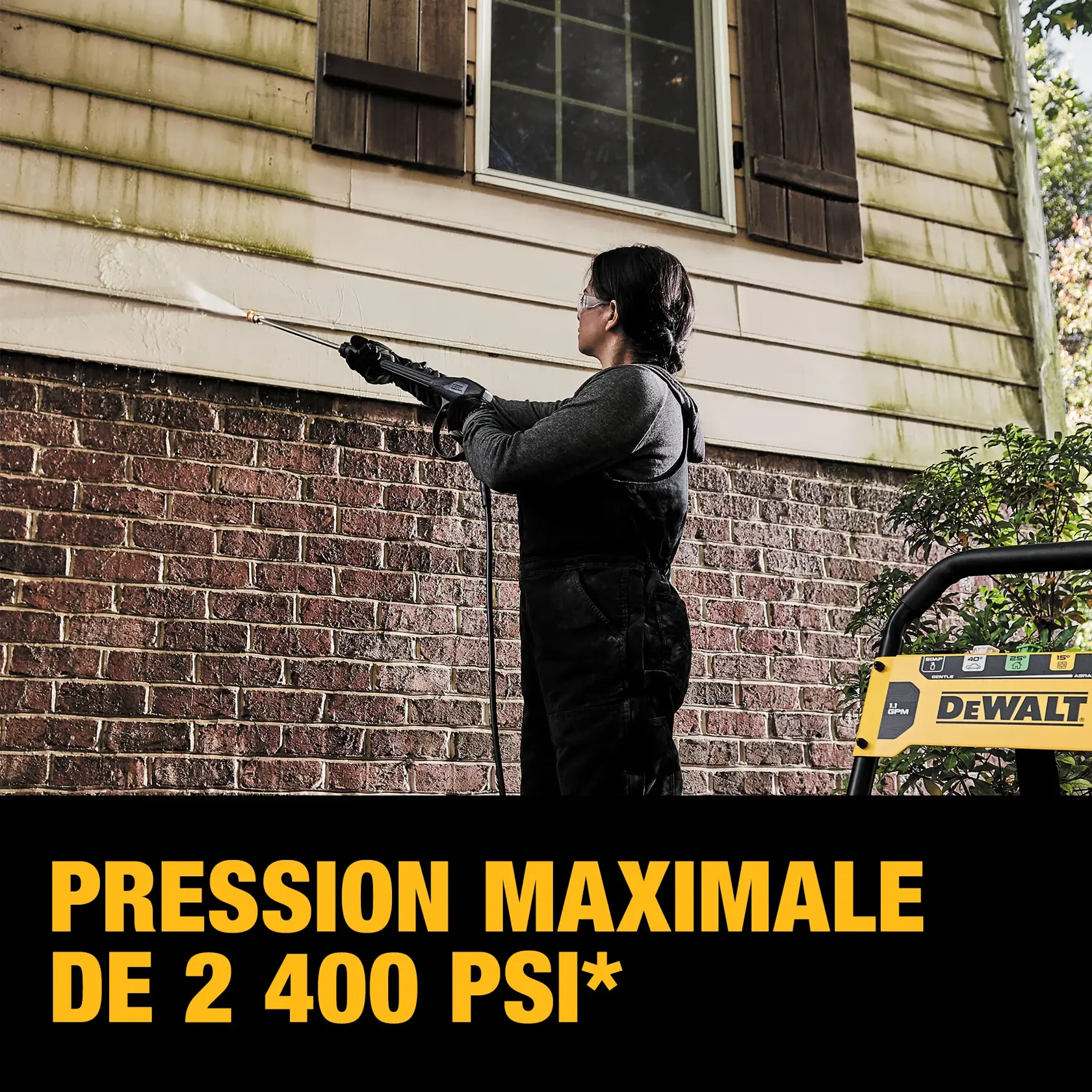 A person is using a DEWALT pressure washer to clean the exterior siding of a house, showing the removal of grime with high water pressure. Text on the image states '2400 MAX PSI WATER PRESSURE.'