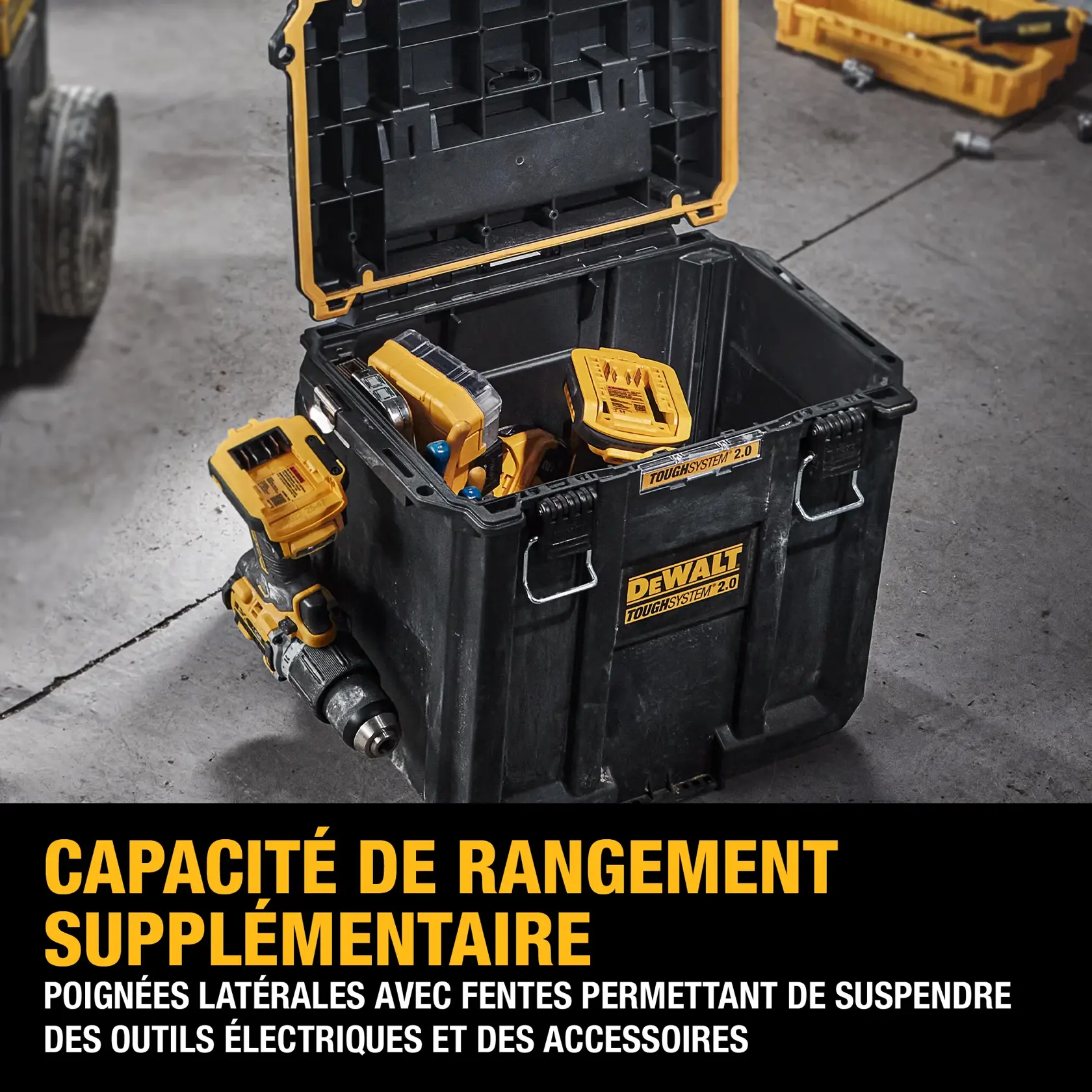A DEWALT ToughSystem 2.0 black and yellow storage box with its lid open, containing power tools and accessories. The box features side handles with slots for hanging electric tools and accessories. The text on the image highlights additional storage capacity and functionality.