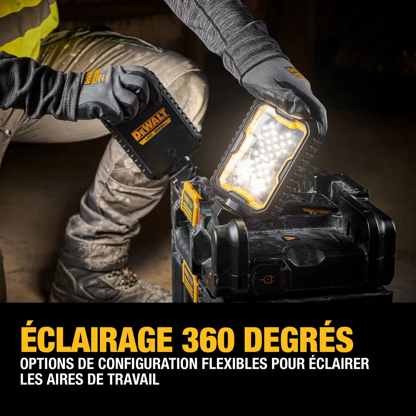 A person wearing work gloves positions a DEWALT LED portable light on top of a black DEWALT tool storage box. The scene highlights the 360-degree lighting capability and flexible configuration options for illuminating work areas.