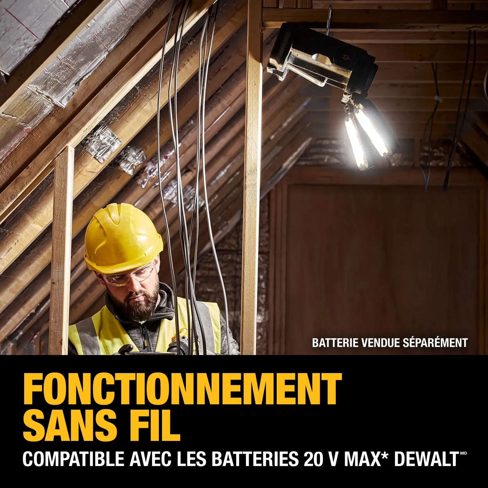 Two workers in safety gear and orange vests use DEWALT portable tool storage carts with multiple drawers on wheels inside a large construction site with concrete columns and overhead lights.