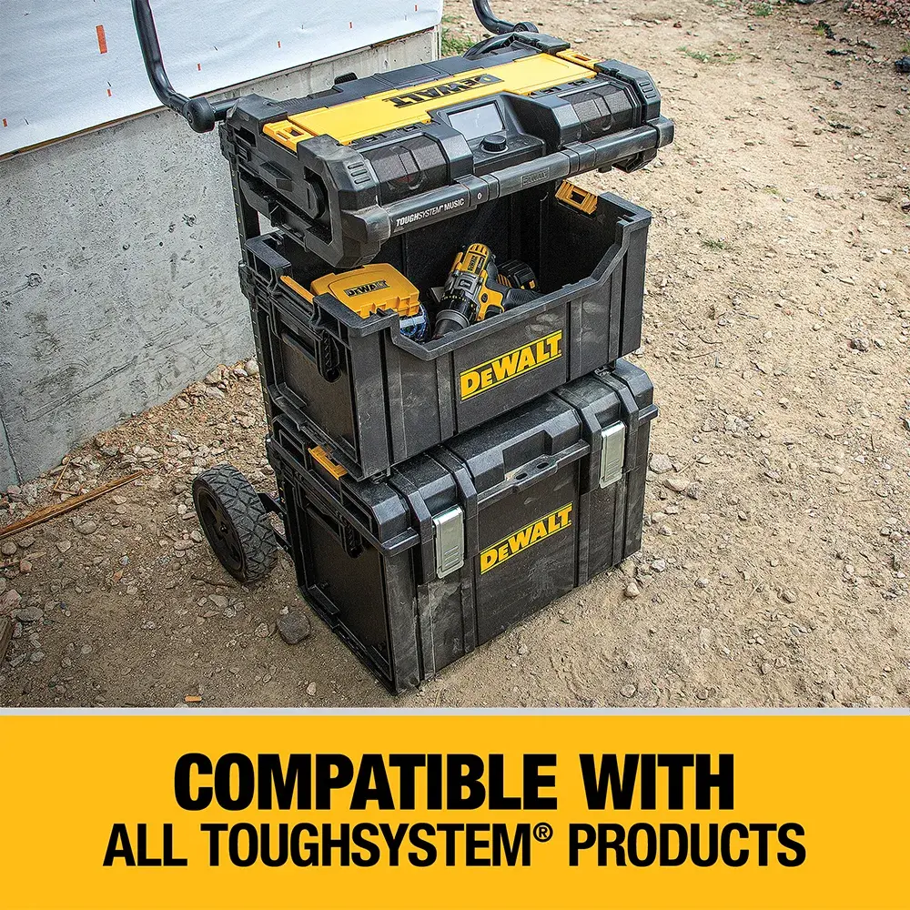 A stack of DEWALT ToughSystem tool storage boxes arranged on a wheeled cart, shown outdoors next to a wall. The lower part of the image features a yellow banner with the text, 'Compatible with all ToughSystem products.'