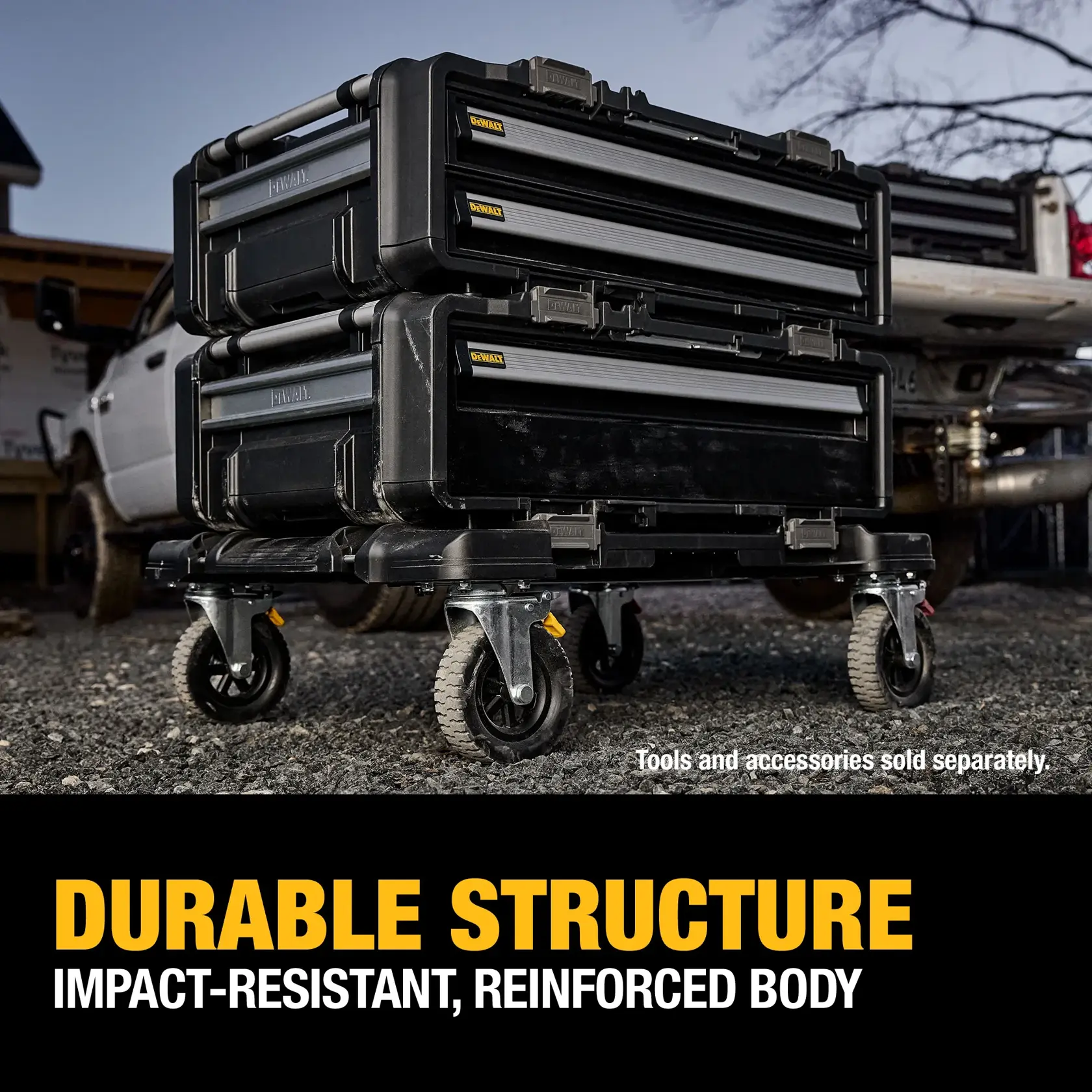 Two DEWALT tool storage boxes with reinforced, impact-resistant bodies are stacked on a wheeled platform outdoors near a pickup truck. The text highlights their durable structure and notes that tools and accessories are sold separately.