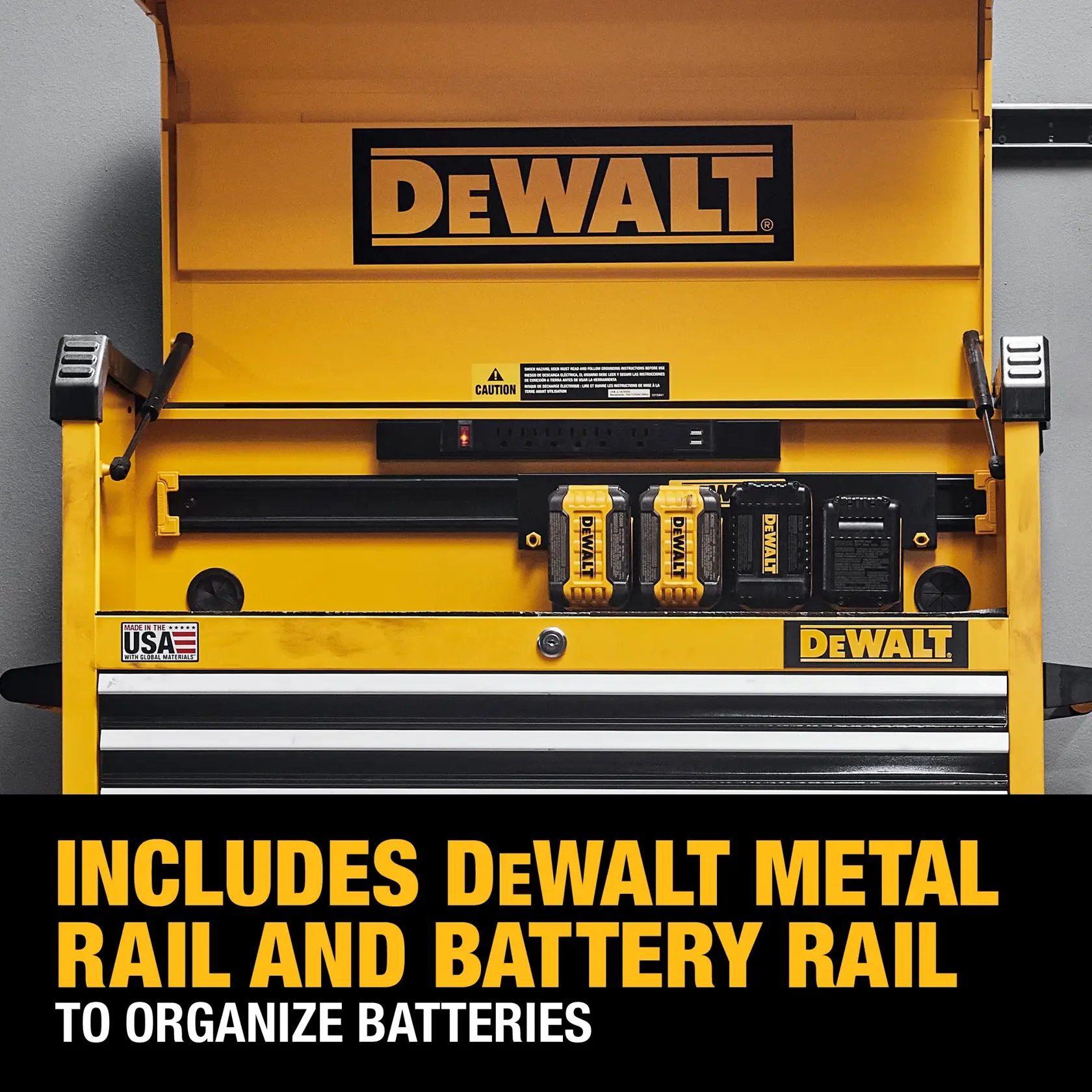 A yellow DEWALT tool chest with metal rail and battery rail for organizing batteries. The chest features the DEWALT logo, compartments for DEWALT batteries, and a made in USA label. Text at the bottom reads: 'Includes DEWALT metal rail and battery rail to organize batteries.'