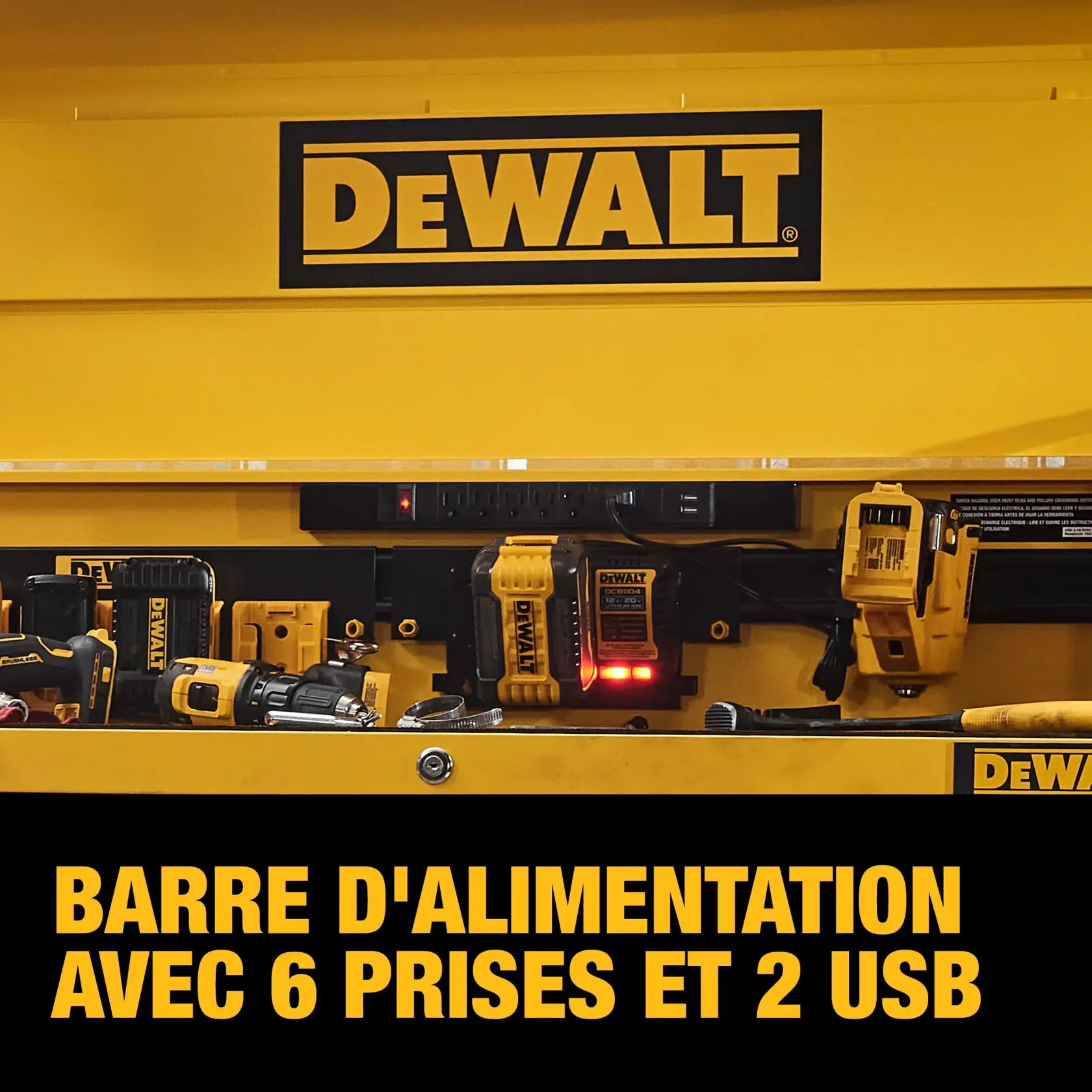 A DEWALT branded yellow workspace featuring a power strip with six outlets and two USB ports, surrounded by various DEWALT tools and chargers.
