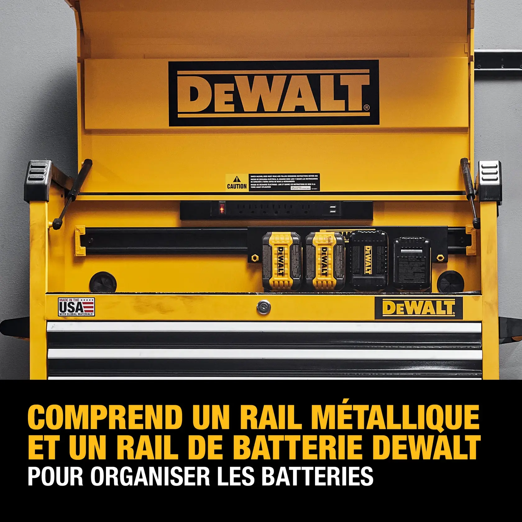 A yellow DEWALT tool chest with metal rail and battery rail for organizing batteries. The chest features the DEWALT logo, compartments for DEWALT batteries, and a made in USA label. Text at the bottom reads: 'Includes DEWALT metal rail and battery rail to organize batteries.'