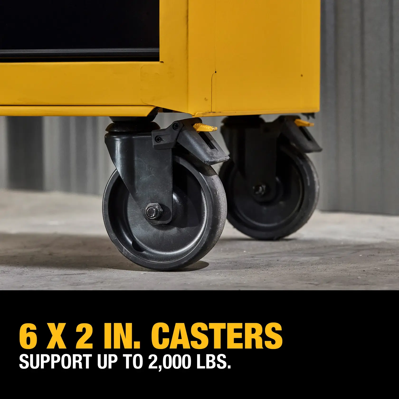 Close-up of two heavy-duty 6 x 2 inch casters attached to a yellow metal cabinet, with text indicating they support up to 2,000 lbs.