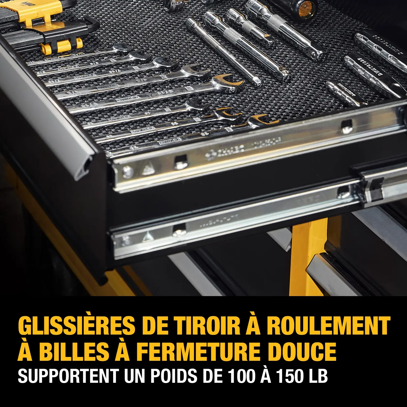 Drawer with soft close, ball-bearing slides holding various hand tools such as wrenches, screwdrivers, and sockets, with text that reads: 'Soft close, ball-bearing drawer slides support 100-150 lbs.'