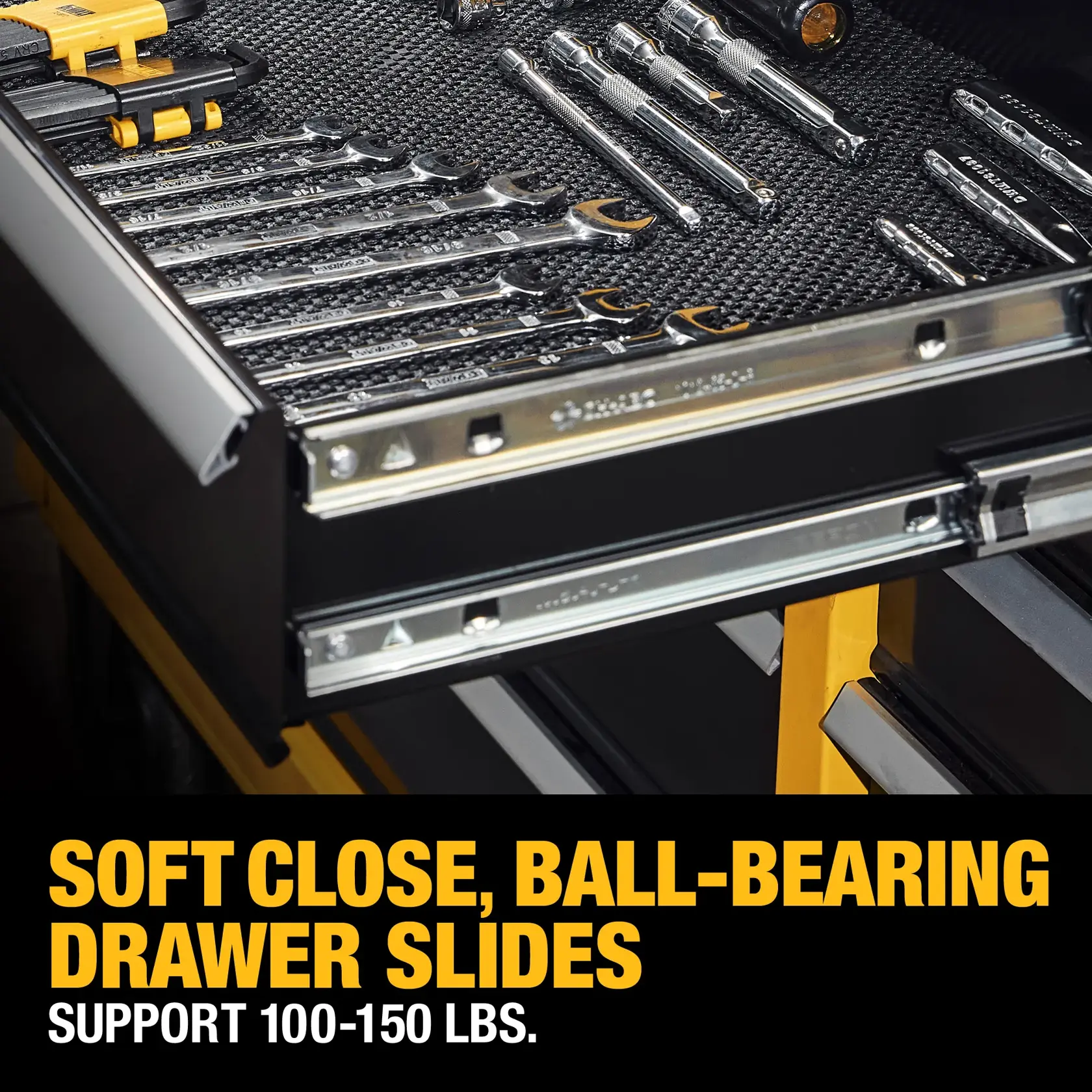 Open drawer in a tool chest showing assorted wrenches and tools organized inside. The text highlights soft close, ball-bearing drawer slides that support 100-150 lbs.