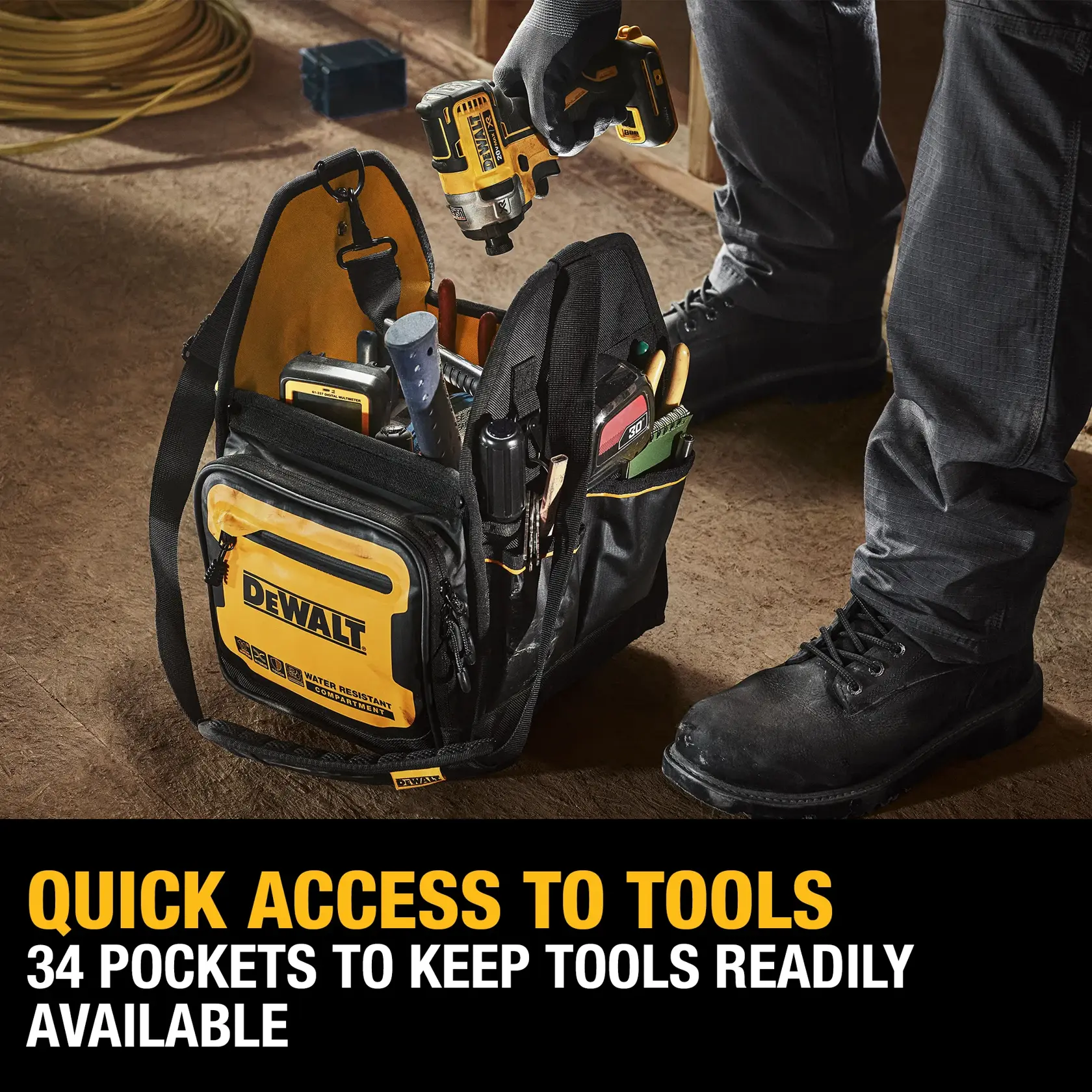 A DEWALT tool bag with multiple tools and a drill inside, being accessed by someone wearing work gloves and boots. The bag has 34 pockets for organizing tools and is shown on a worksite floor. A yellow DEWALT logo is visible on the front.