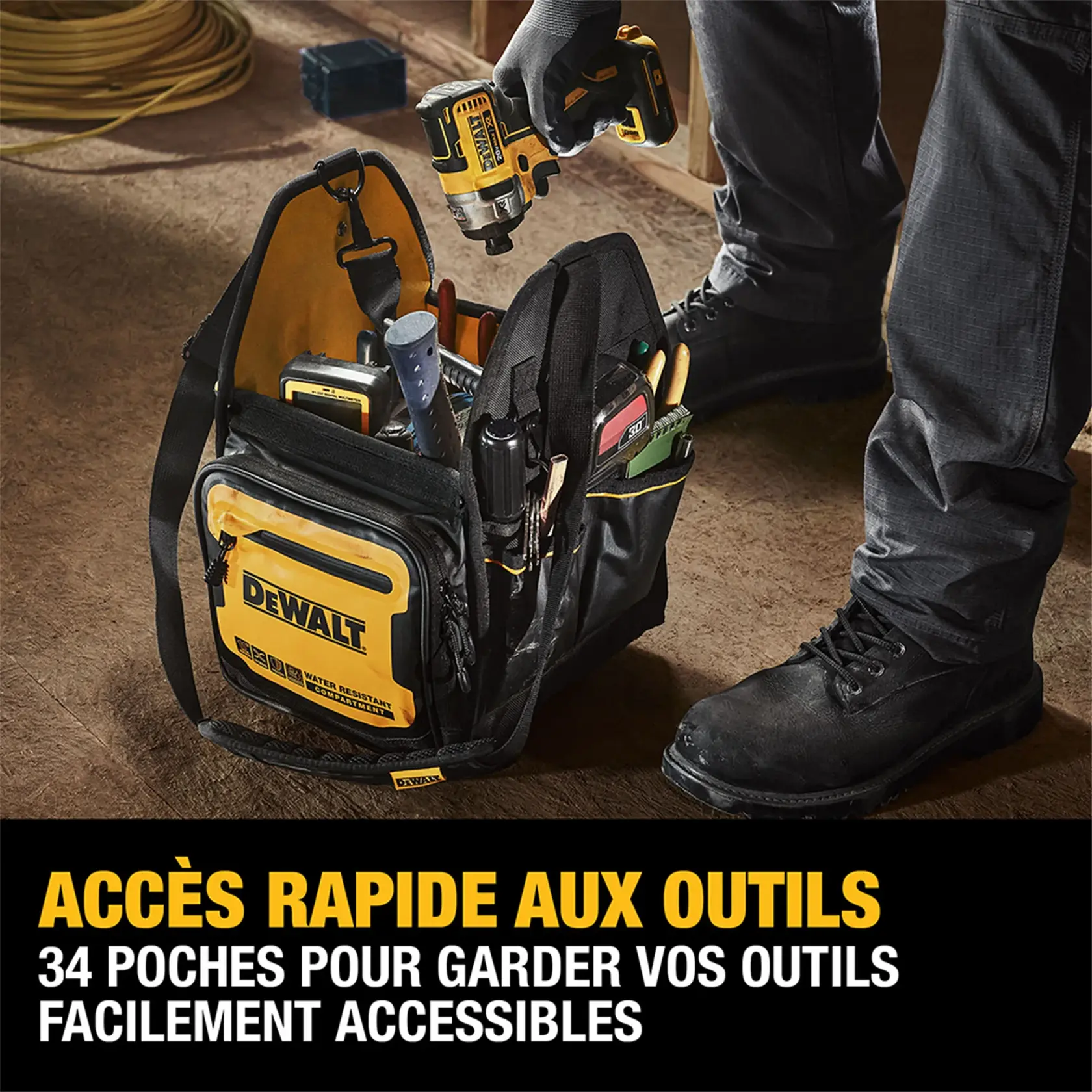 A DEWALT tool bag with multiple tools and a drill inside, being accessed by someone wearing work gloves and boots. The bag has 34 pockets for organizing tools and is shown on a worksite floor. A yellow DEWALT logo is visible on the front.