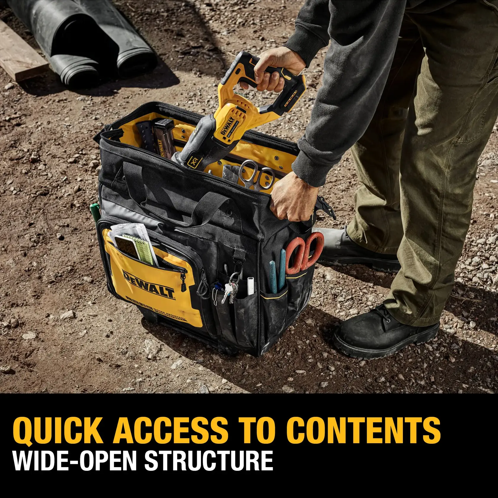 A person pulls a DEWALT rolling tool bag with an extendable handle outdoors at a construction site. The bag is black and yellow, featuring multiple exterior pockets filled with tools. Promotional text below highlights storage optimization, 27 pockets, and a personal effects compartment.