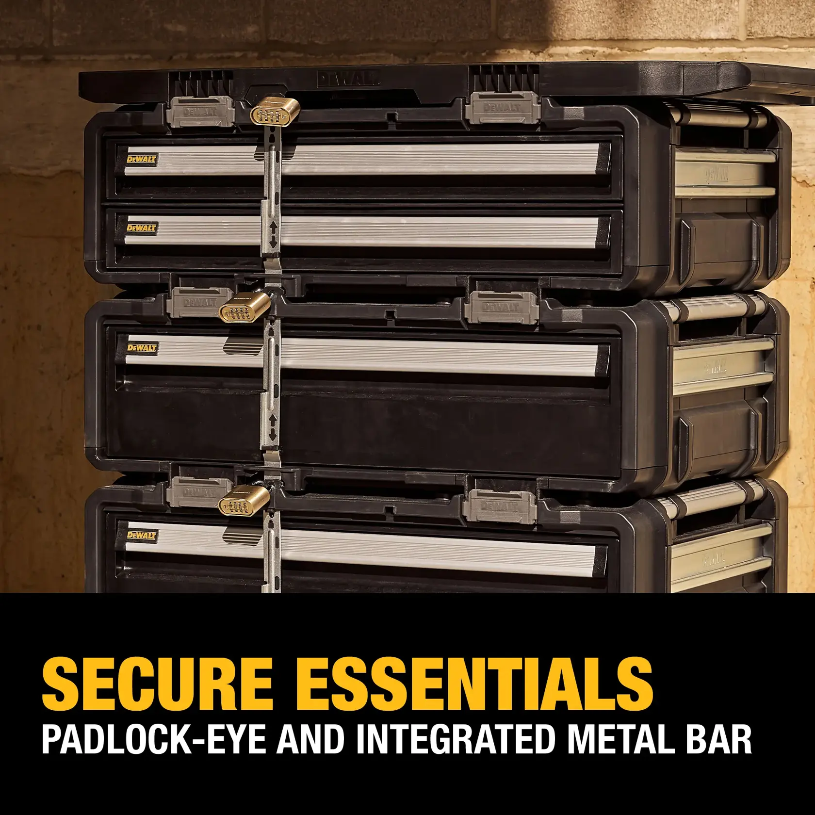 Stacked DEWALT storage boxes secured with metal bars and padlocks, shown against a workshop wall. The text at the bottom reads: 'SECURE ESSENTIALS PADLOCK-EYE AND INTEGRATED METAL BAR.'