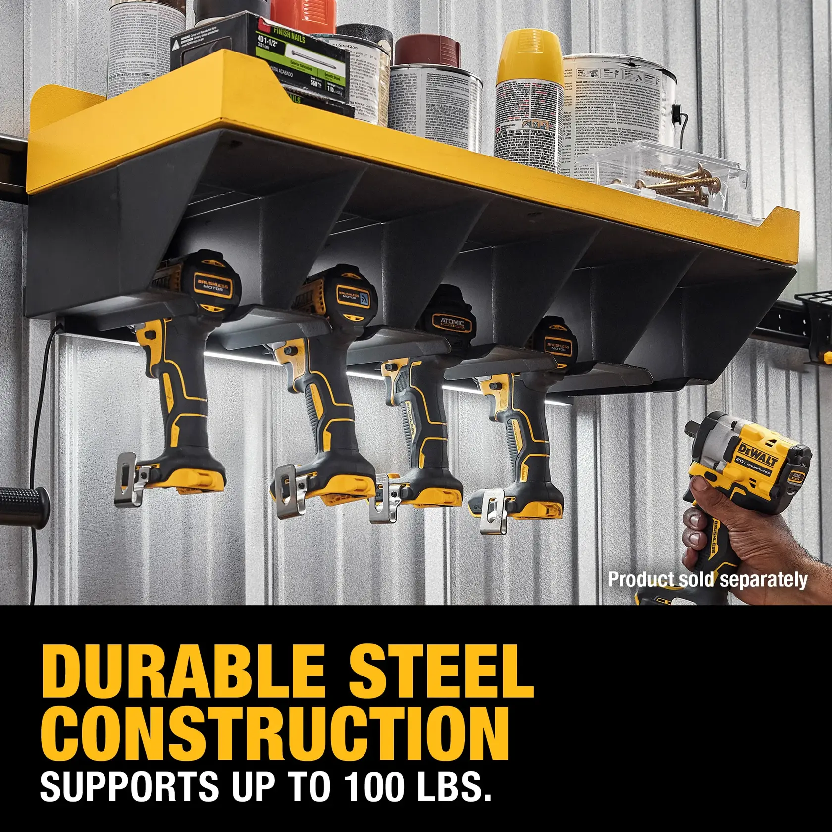 A DEWALT steel wall-mounted shelf holding four DEWALT power tools underneath, with various cans and boxes stored on the top. The shelf is advertised as durable and supports up to 100 lbs. Text reads: 'Durable steel construction. Supports up to 100 lbs.'