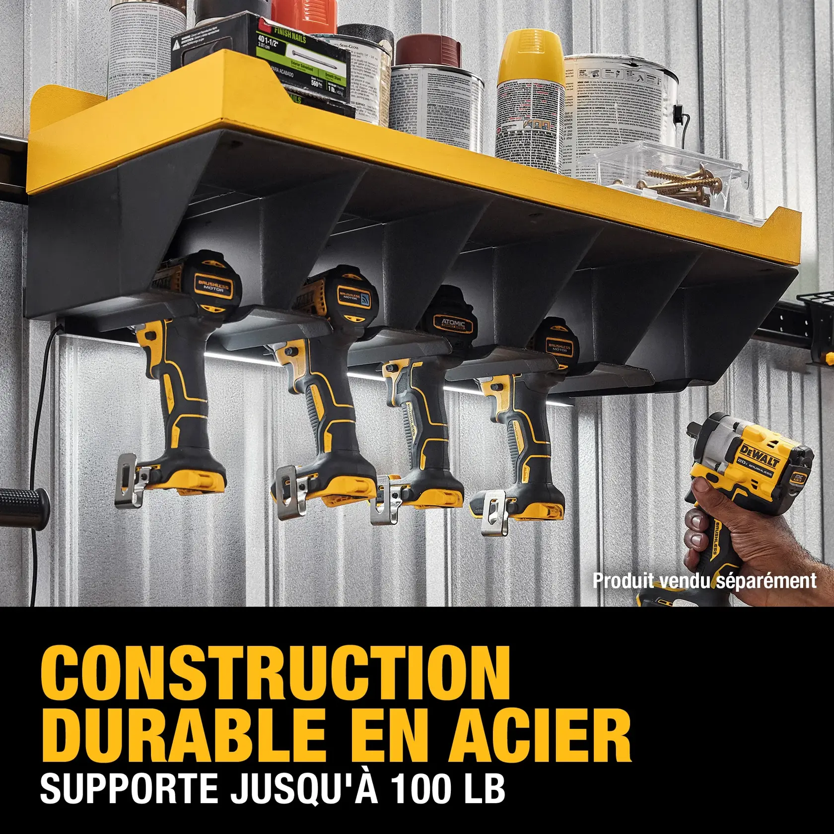 A DEWALT steel wall-mounted shelf holding four DEWALT power tools underneath, with various cans and boxes stored on the top. The shelf is advertised as durable and supports up to 100 lbs. Text reads: 'Durable steel construction. Supports up to 100 lbs.'