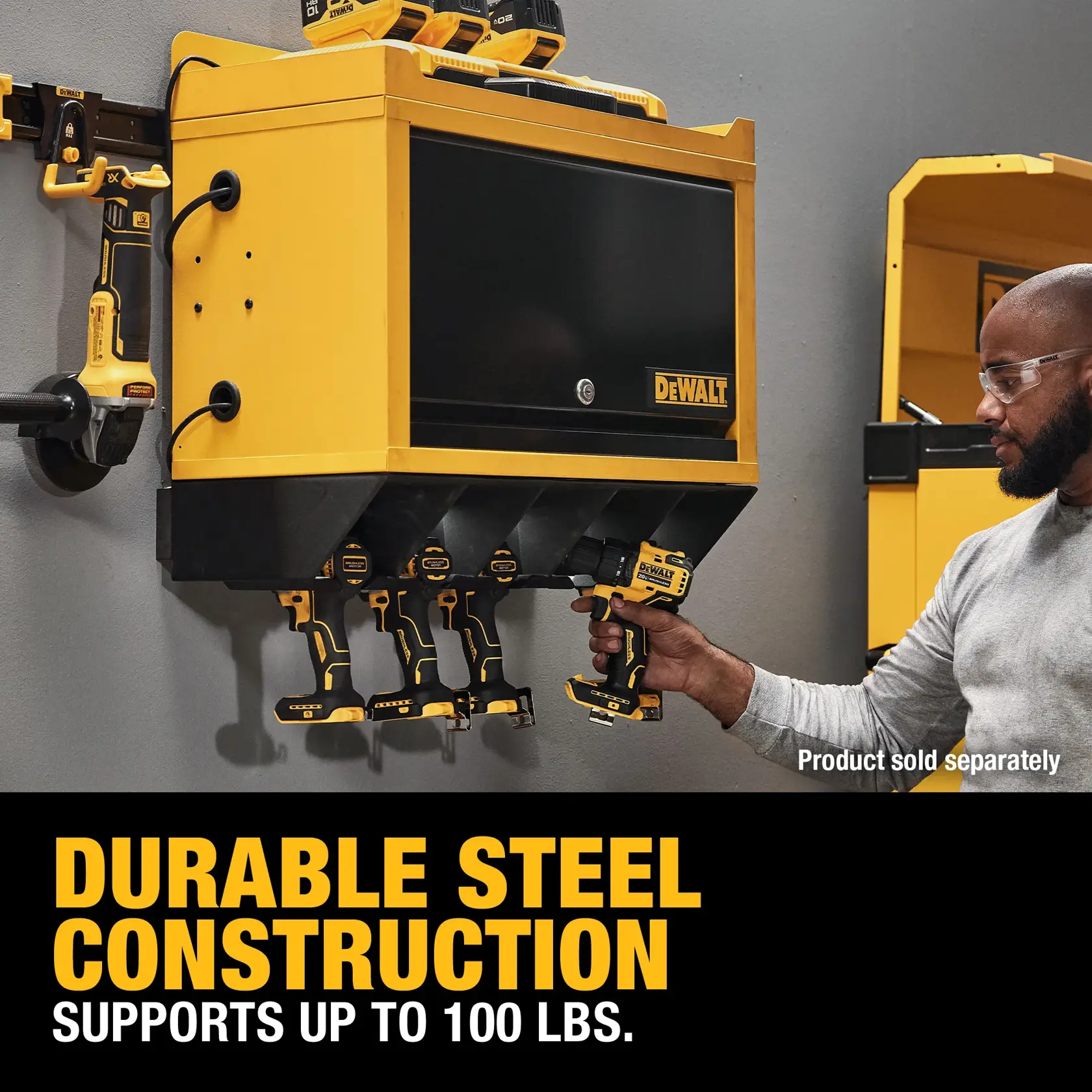 A DEWALT steel wall-mounted tool storage cabinet with several power tools organized below and on the sides. A person is grabbing a tool from the cabinet. Text on the image states: 'DURABLE STEEL CONSTRUCTION SUPPORTS UP TO 100 LBS.' and 'Product sold separately.'