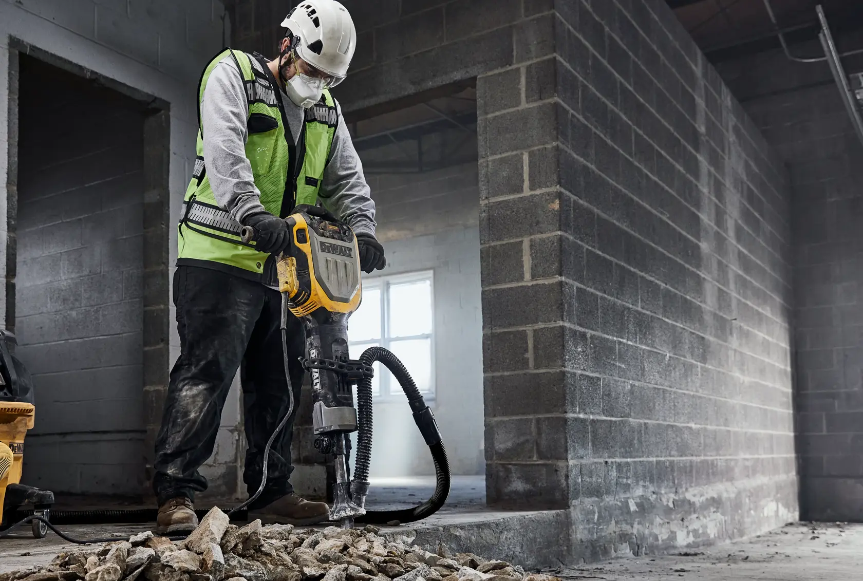 DEWALT D25966K, D25966-B2 breaker in use at construction site, worker in safety gear breaking concrete.