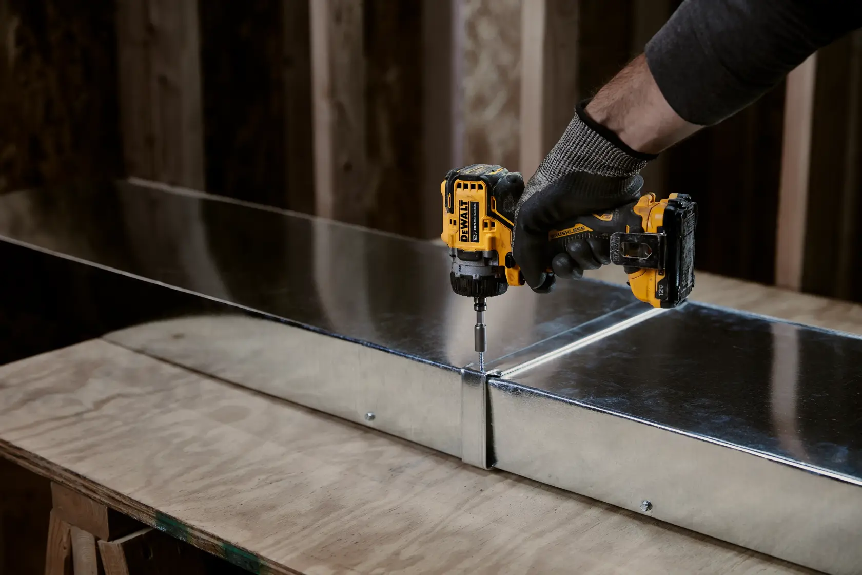 DEWALT drill base with LED foot light shining on wood surface, brightening workspace.