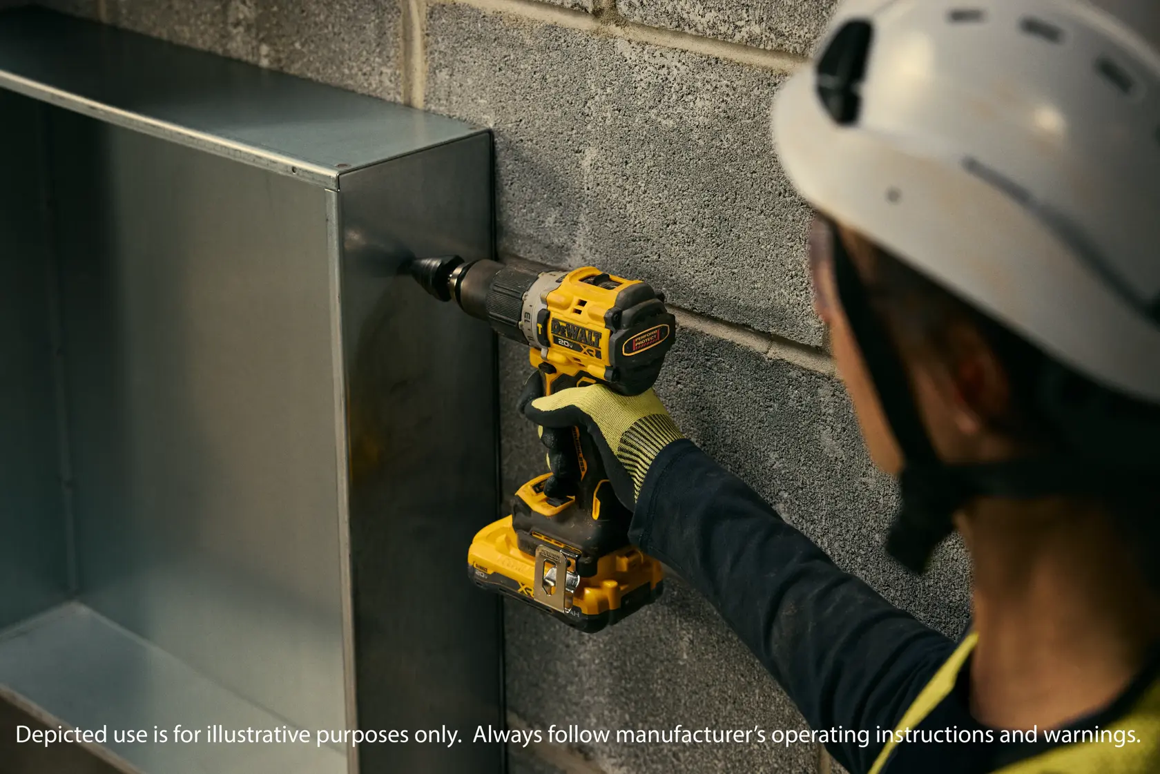 A person wearing protective gear, including a helmet and gloves, is using a yellow DEWALT cordless drill to drill into a metal surface mounted against a concrete wall.