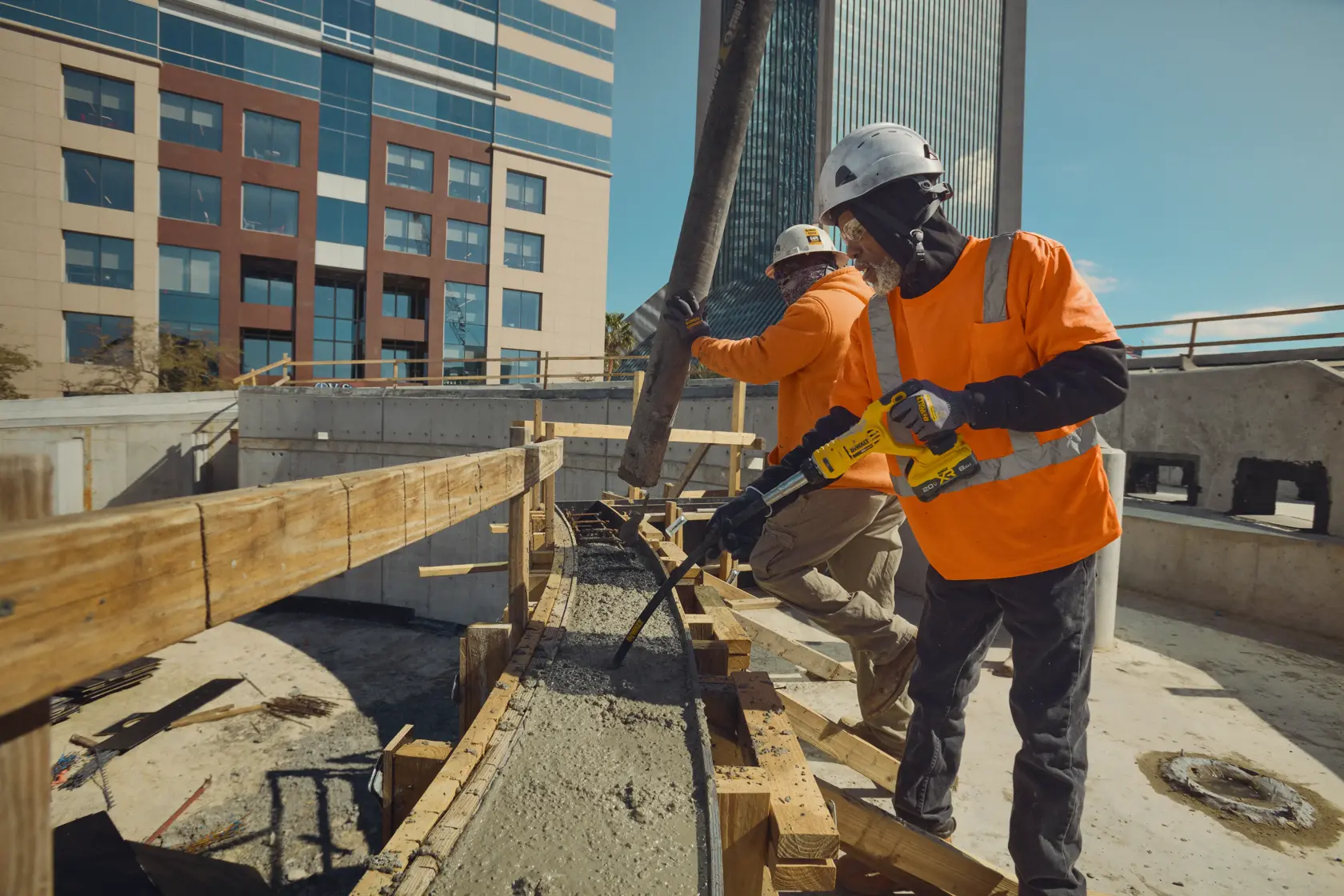 Image of a DEWALT DCE531B concrete vibrator tool with key features highlighted. The tool has a 1-1/8 inch diameter head, a 4 foot shaft, and operates up to 14,000 vibrations per minute under load. The tool is shown in a side view with labeled specifications.