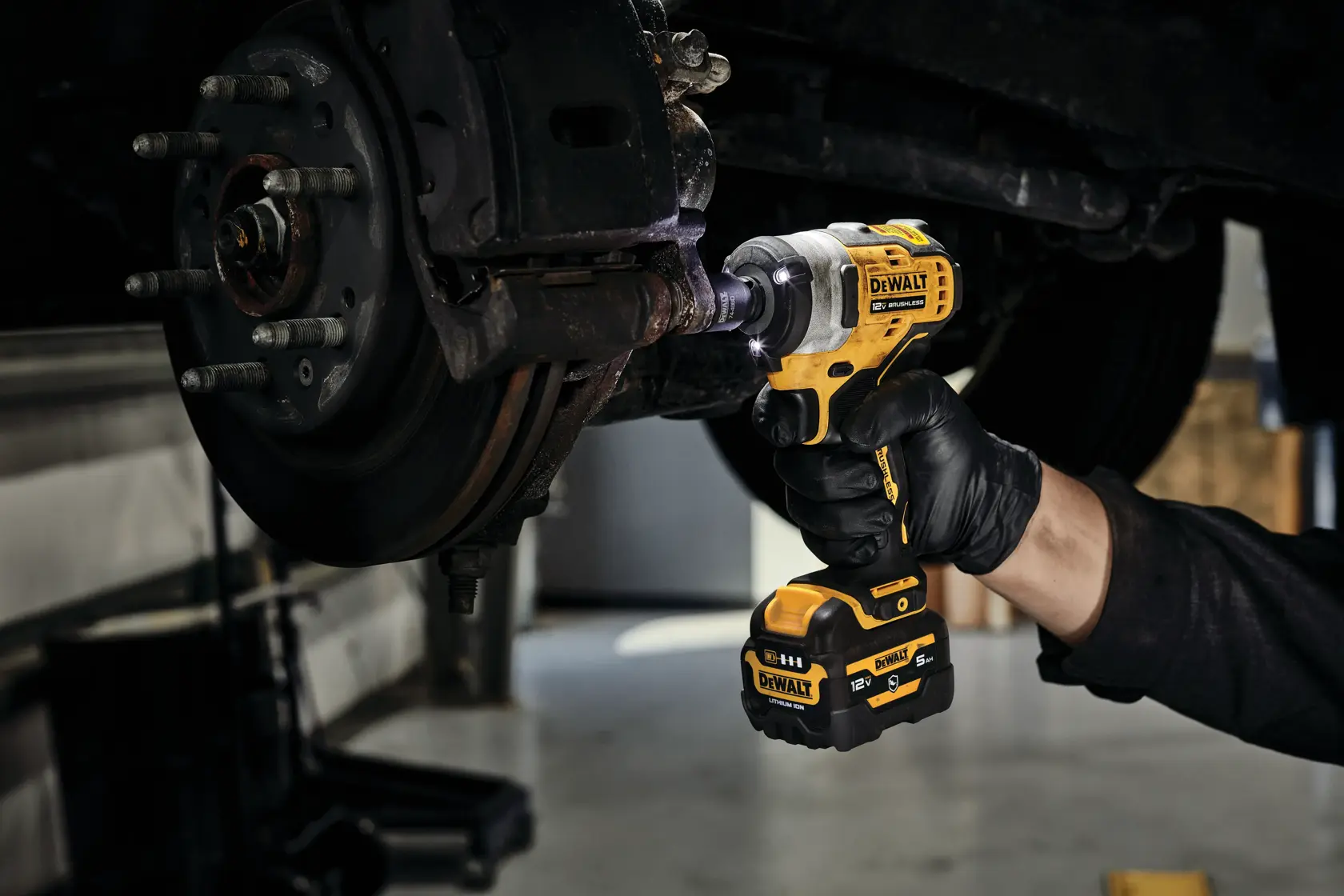 CORDLESS IMPACT WRENCH with battery stand in action
