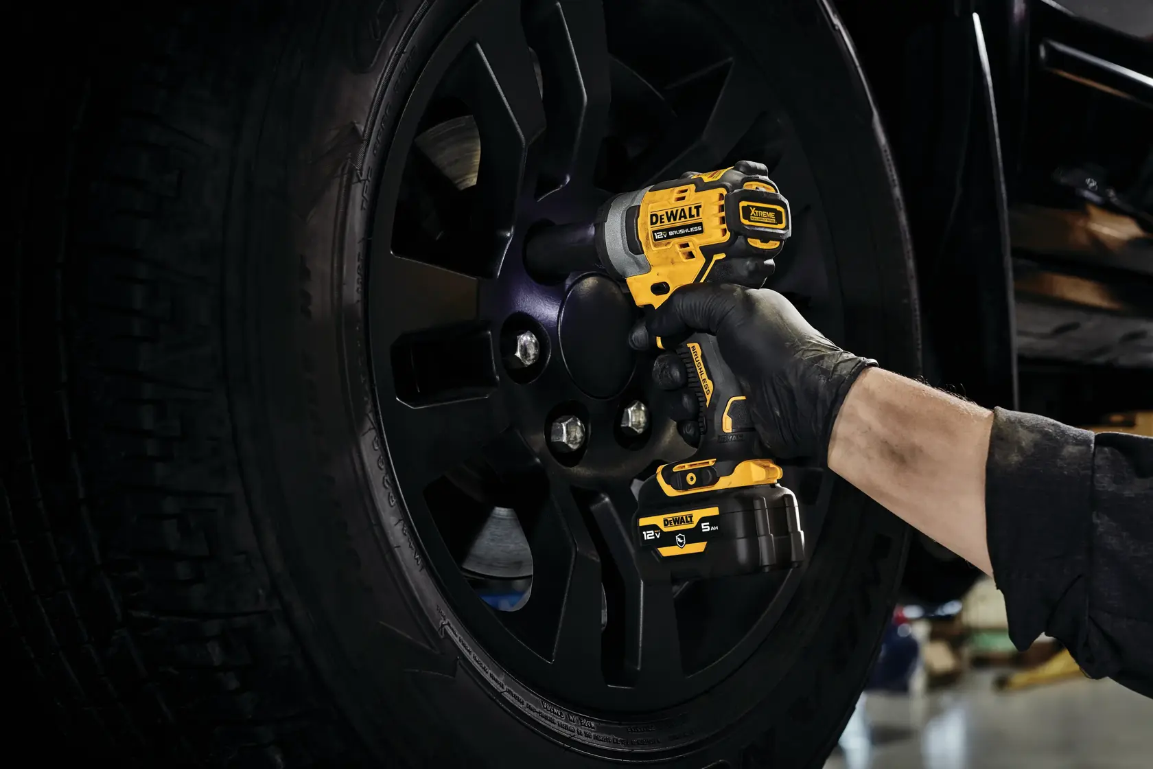 CORDLESS IMPACT WRENCH with battery stand in action