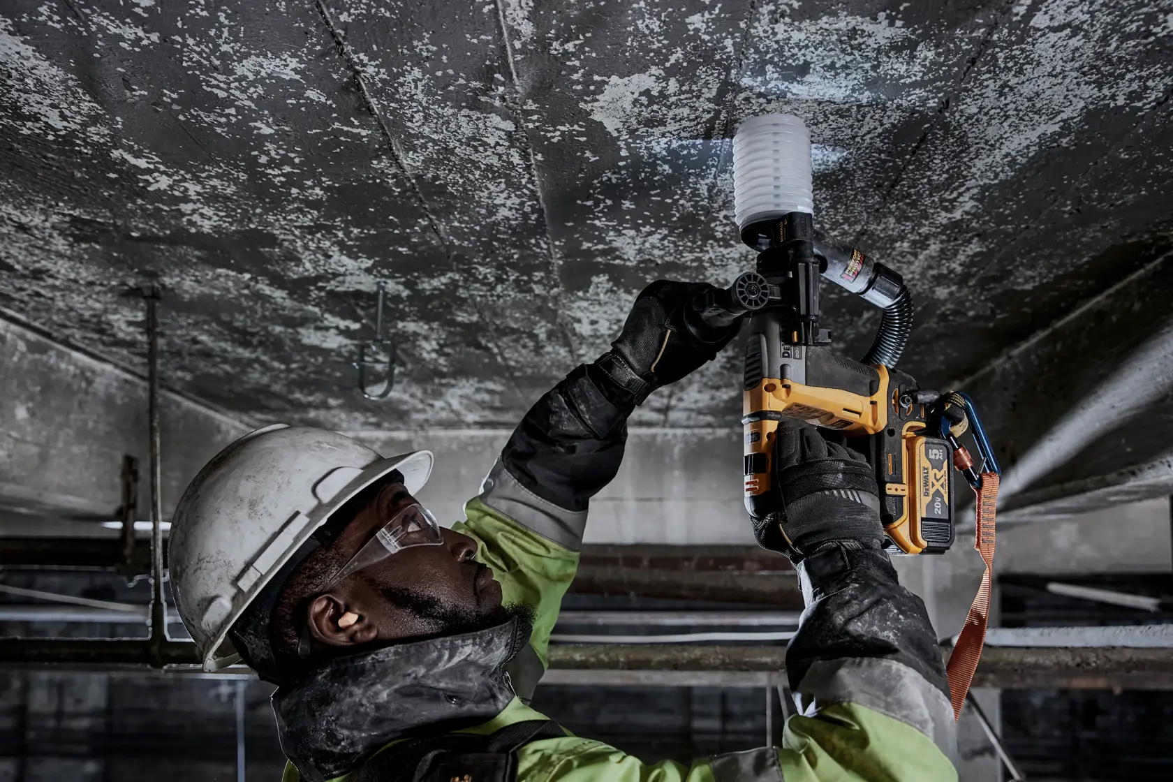 Close-up image of a DEWALT power tool showing the mode selector switch, which allows users to easily switch between drill and hammer drill modes. The tool is resting on a textured surface, and yellow and black colors are visible. Text below highlights the feature: 'Mode Selector Switch. Easily switch between drill and hammer drill mode.'