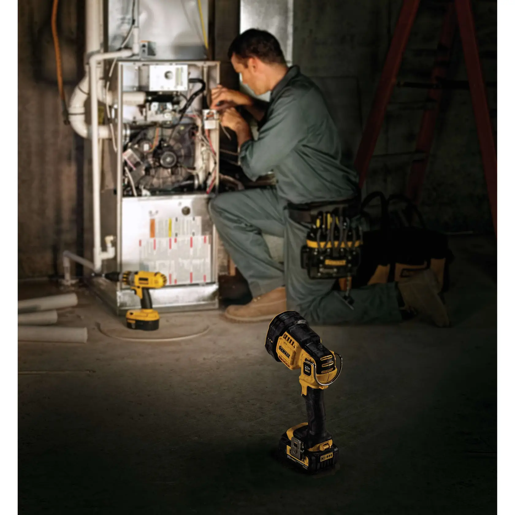 A person kneels and works on a furnace in a workshop or basement, with DEWALT tools including a cordless spotlight (DCL043) prominently shown in the foreground and other DEWALT tools placed nearby. The person's face is blurred for privacy.