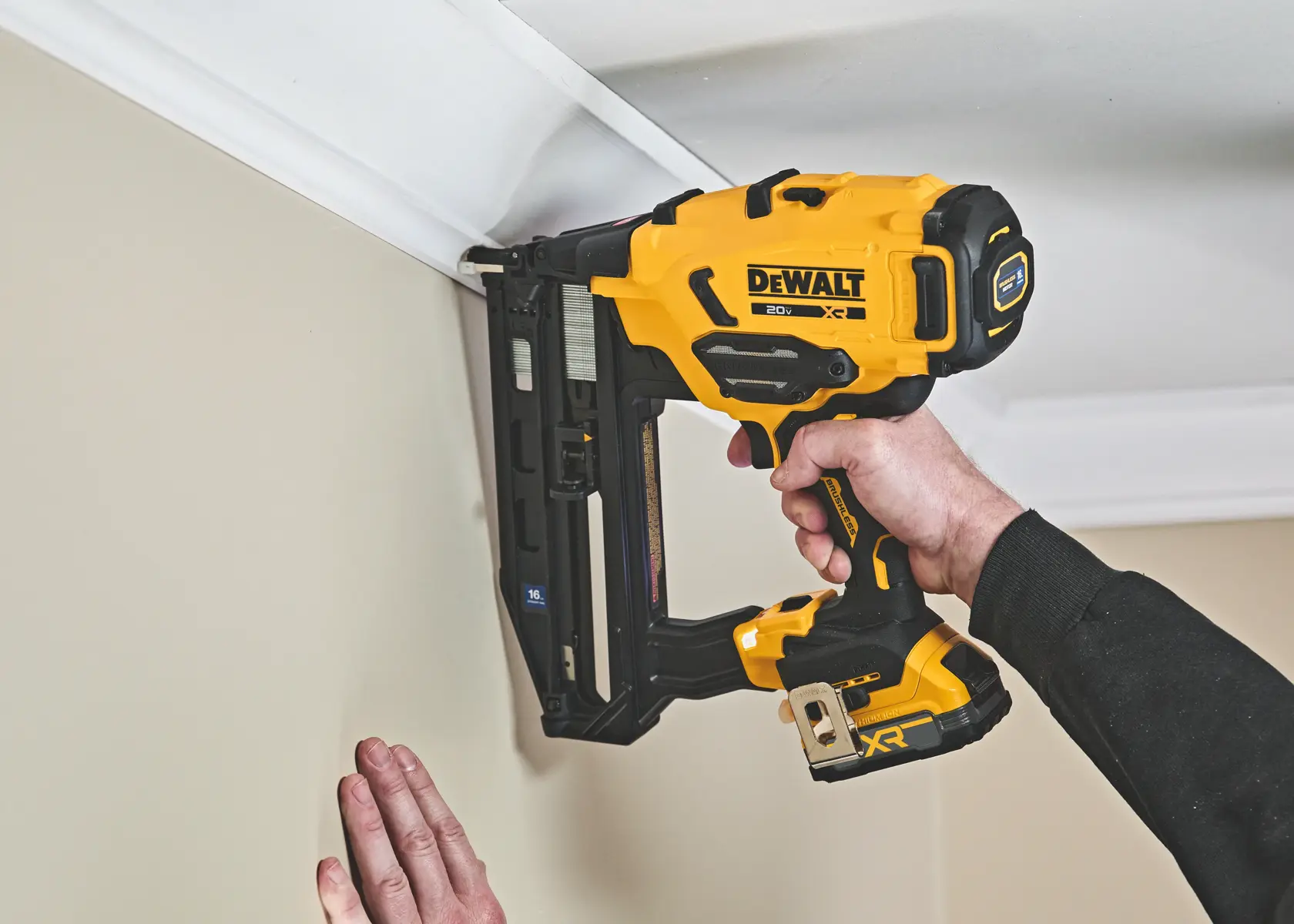 DEWALT 20V XR cordless brushless 16-gauge finish nailer, yellow and black tool, side view.
