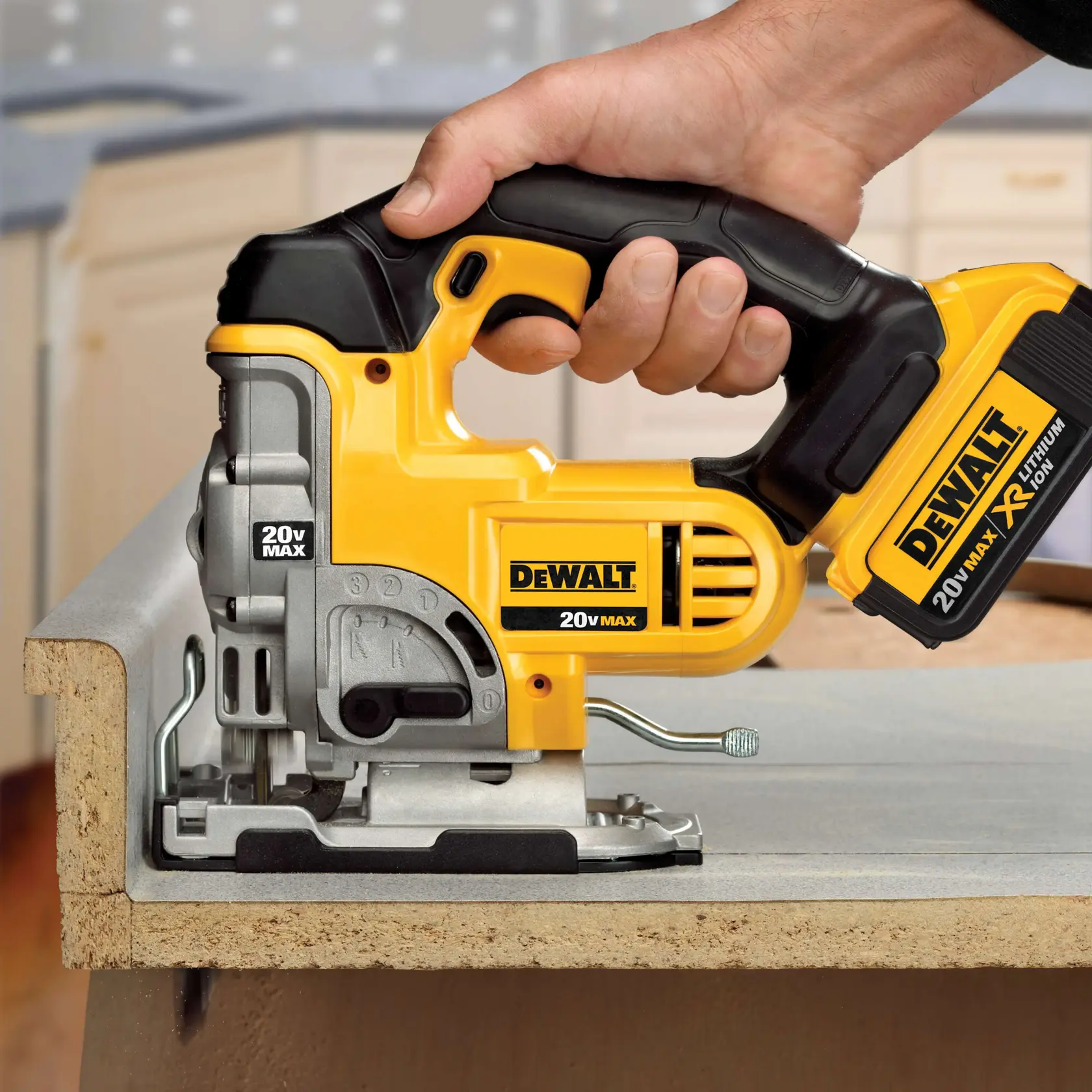 A close-up of a person using a yellow and black DEWALT 20V Max cordless jigsaw to cut through a piece of wood on a workbench.