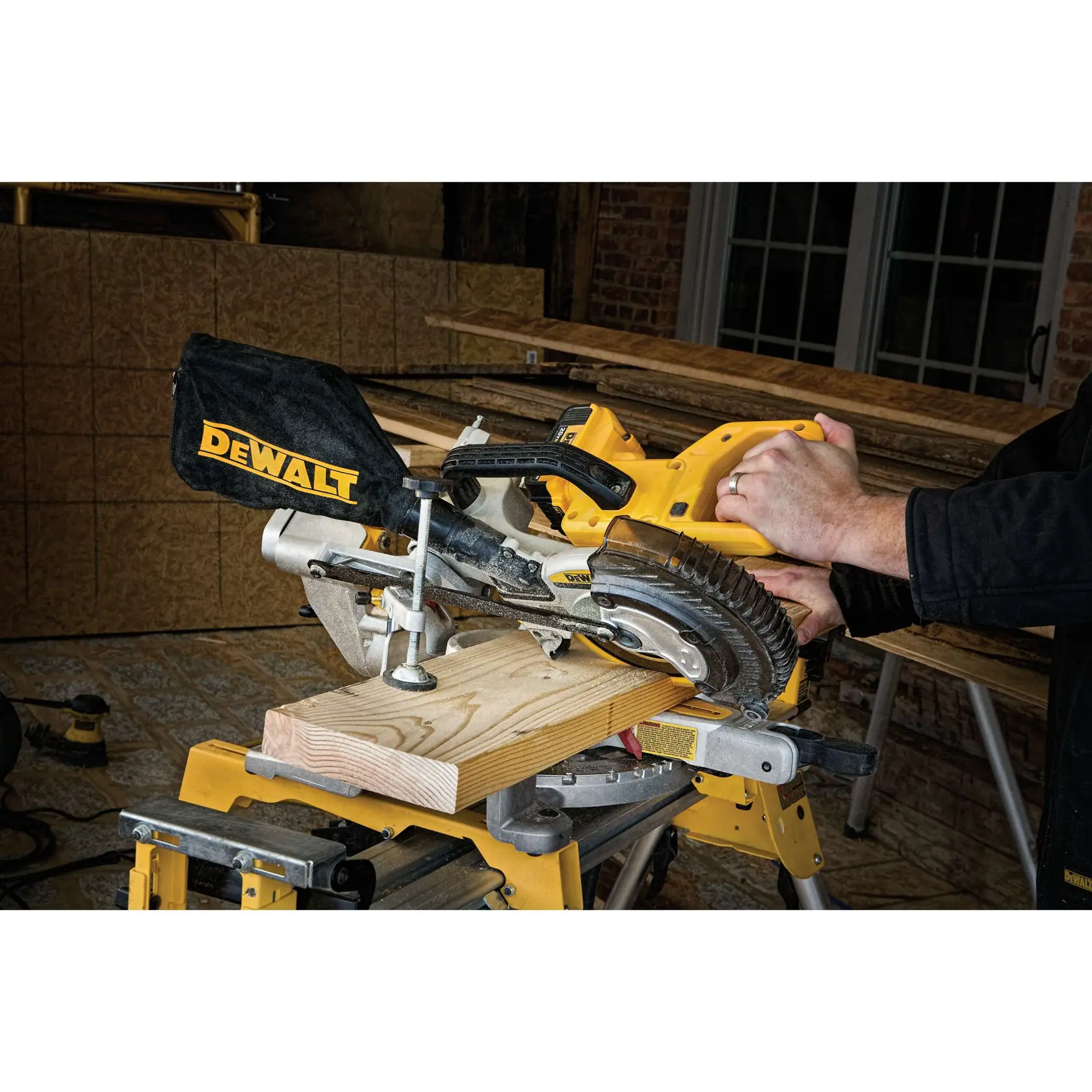 Close-up of DEWALT miter saw showing stainless steel miter detent plate and angle markings.