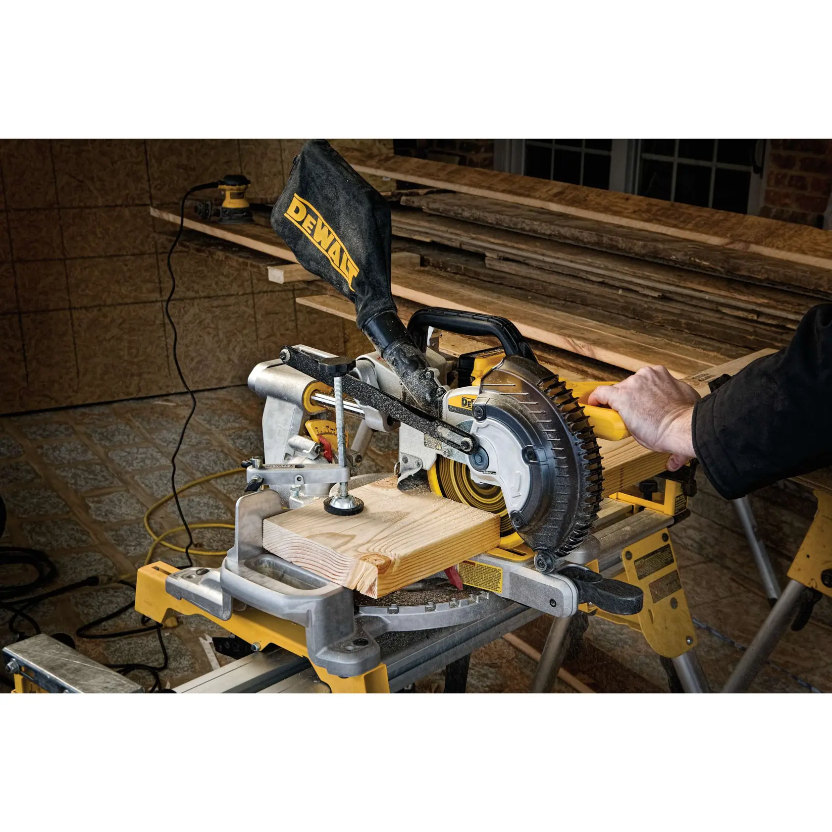Close-up of a DEWALT cam lock miter handle with yellow label showing product feature.