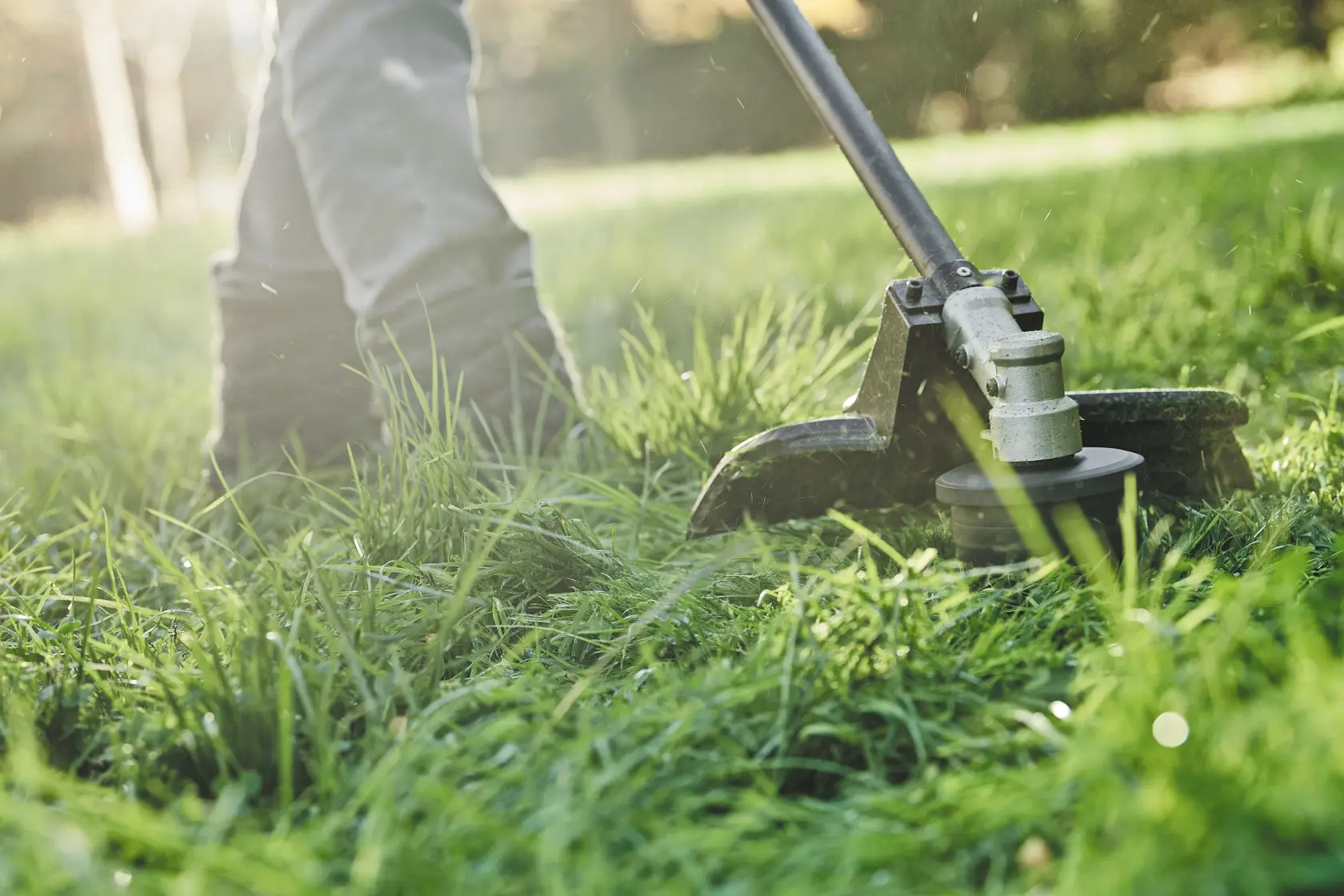 A DEWALT string trimmer cutting grass, with text overlay highlighting its adjustable cutting swath between 15 and 17 inches and a 0.080 inch dual line feature.