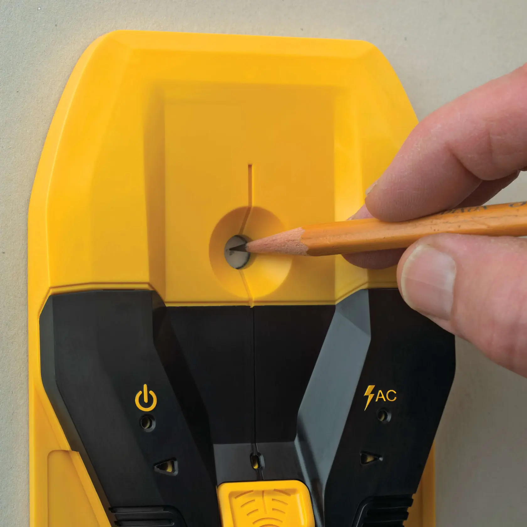 A DEWALT handheld center-finding stud finder with black and yellow design held against a wall, featuring the words 'CENTER-FIND TECHNOLOGY' in bold letters below the device.