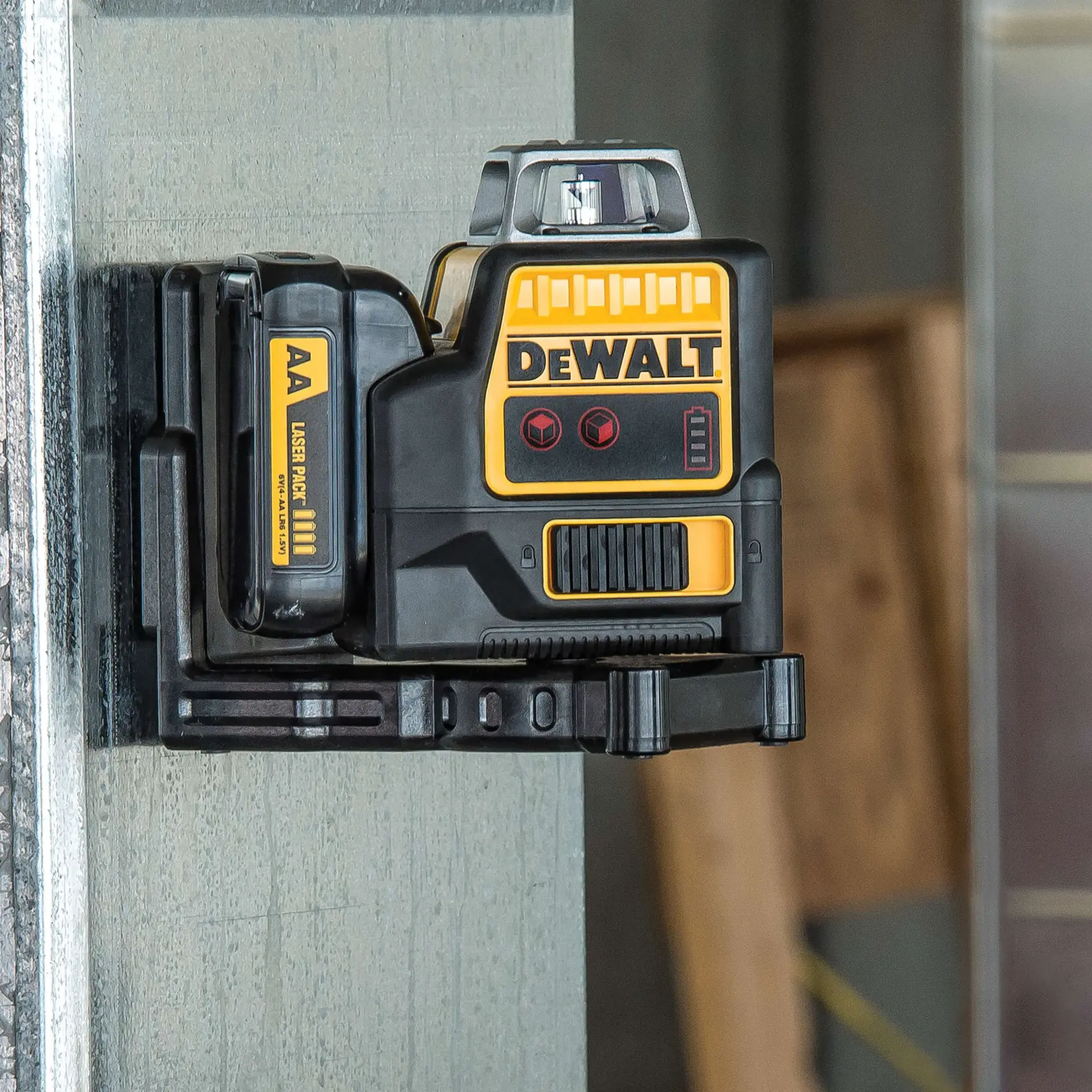 A DEWALT DW0811LR laser level mounted on a metal surface in a construction setting.