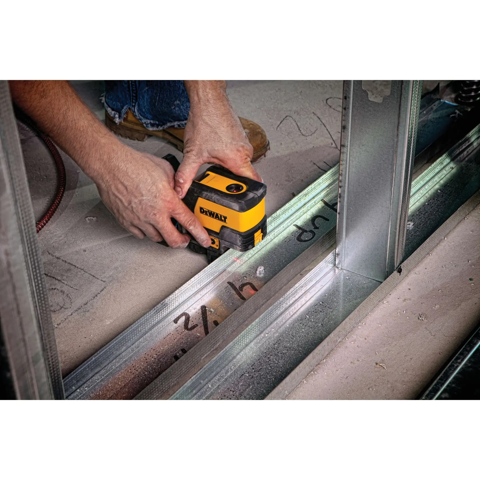 DEWALT DW0822CG, DW0822 tool used for layout work on a construction floor with steel framing visible.