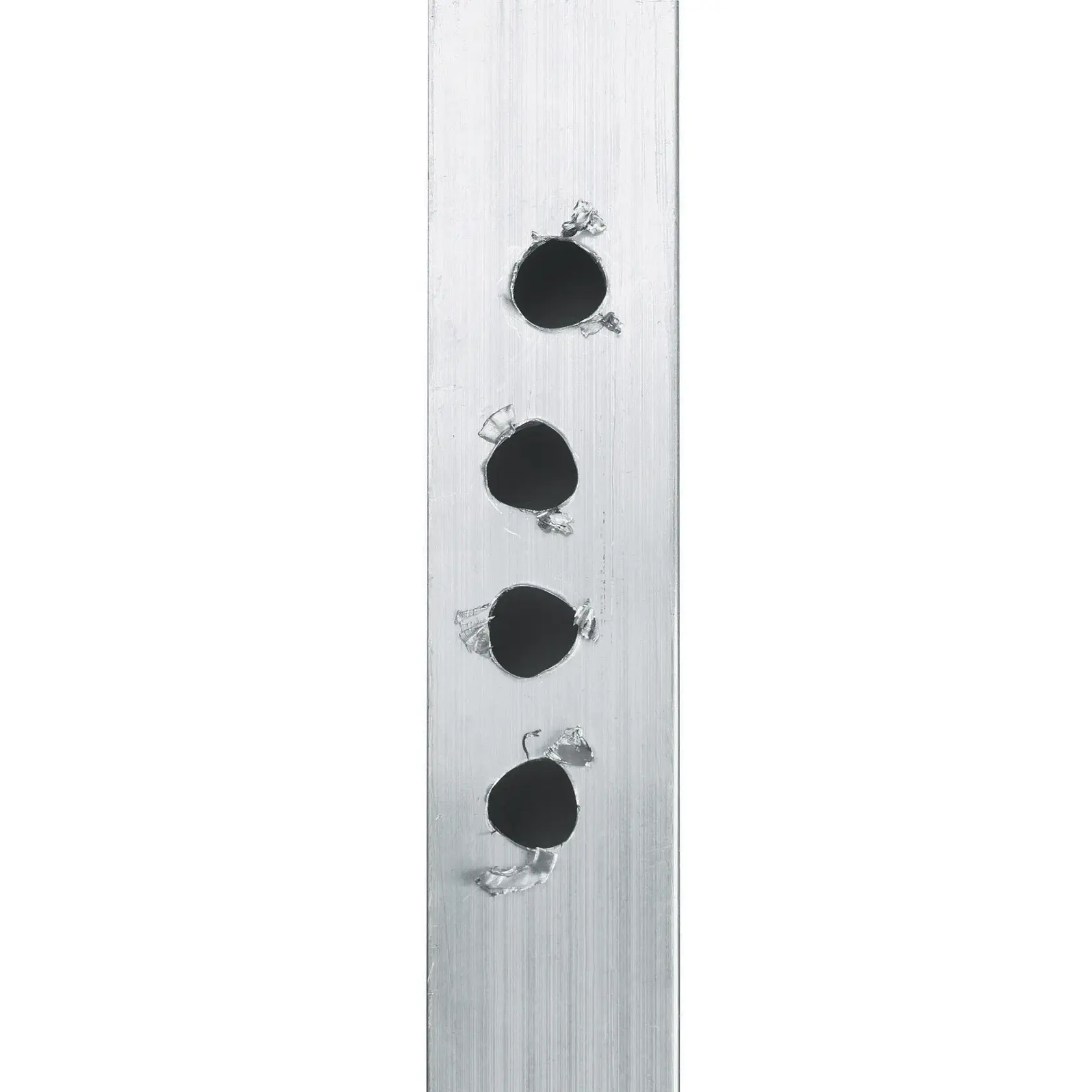 A close-up image of a metal strip with four evenly spaced round holes drilled into it. The edges of each hole show some metal shavings, indicating the holes were recently drilled.