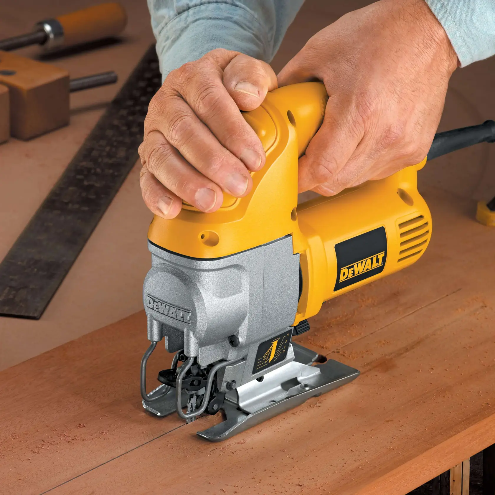 A DEWALT DW317K jigsaw with highlighted features: all-metal gear case, variable speed, lever-action blade clamp, 4-position orbital action, and shoe bevels from 0° to 45°.