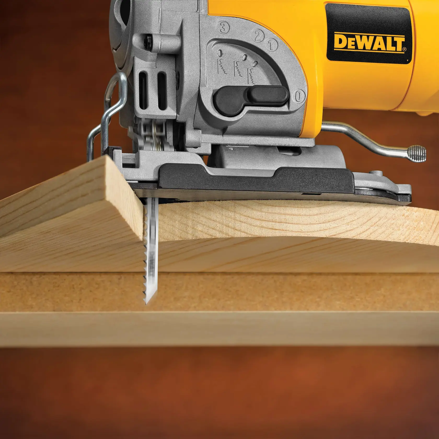 Close-up of a DEWALT electric jigsaw cutting through a wooden plank.