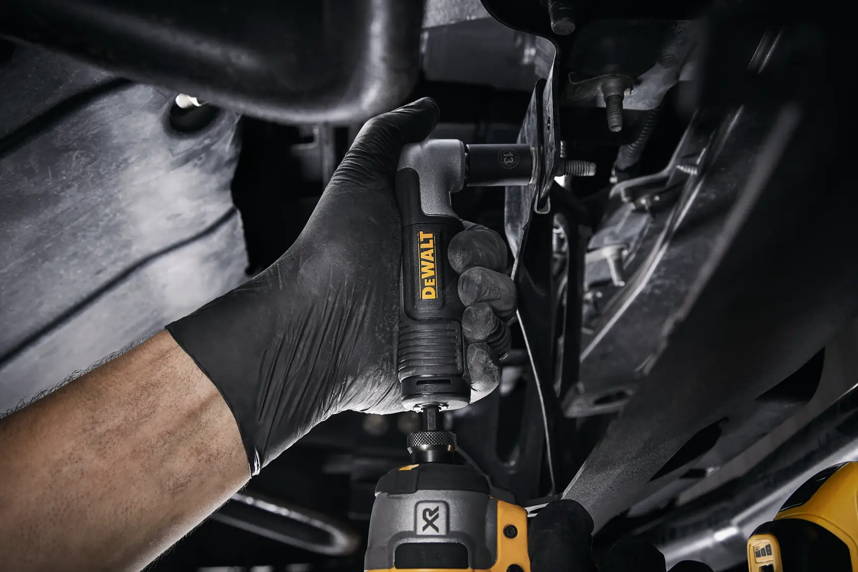 Three DEWALT drill accessories laid out on a white background. The top item is a right angle drill adapter with a silver and black finish. The middle item is a black drill handle with textured grip and the yellow DEWALT logo. The bottom item is a detachable black side handle.