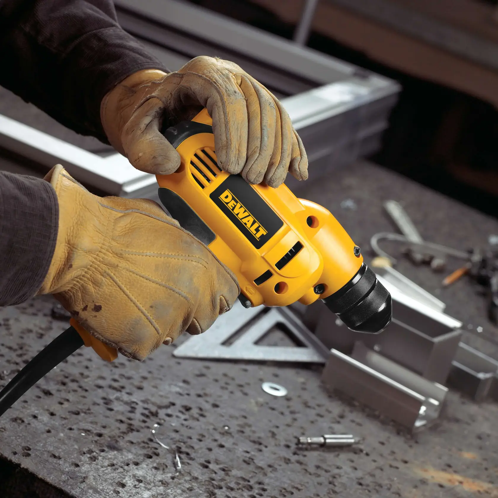 A person is using a yellow DEWALT electric drill to drill into a metal surface.