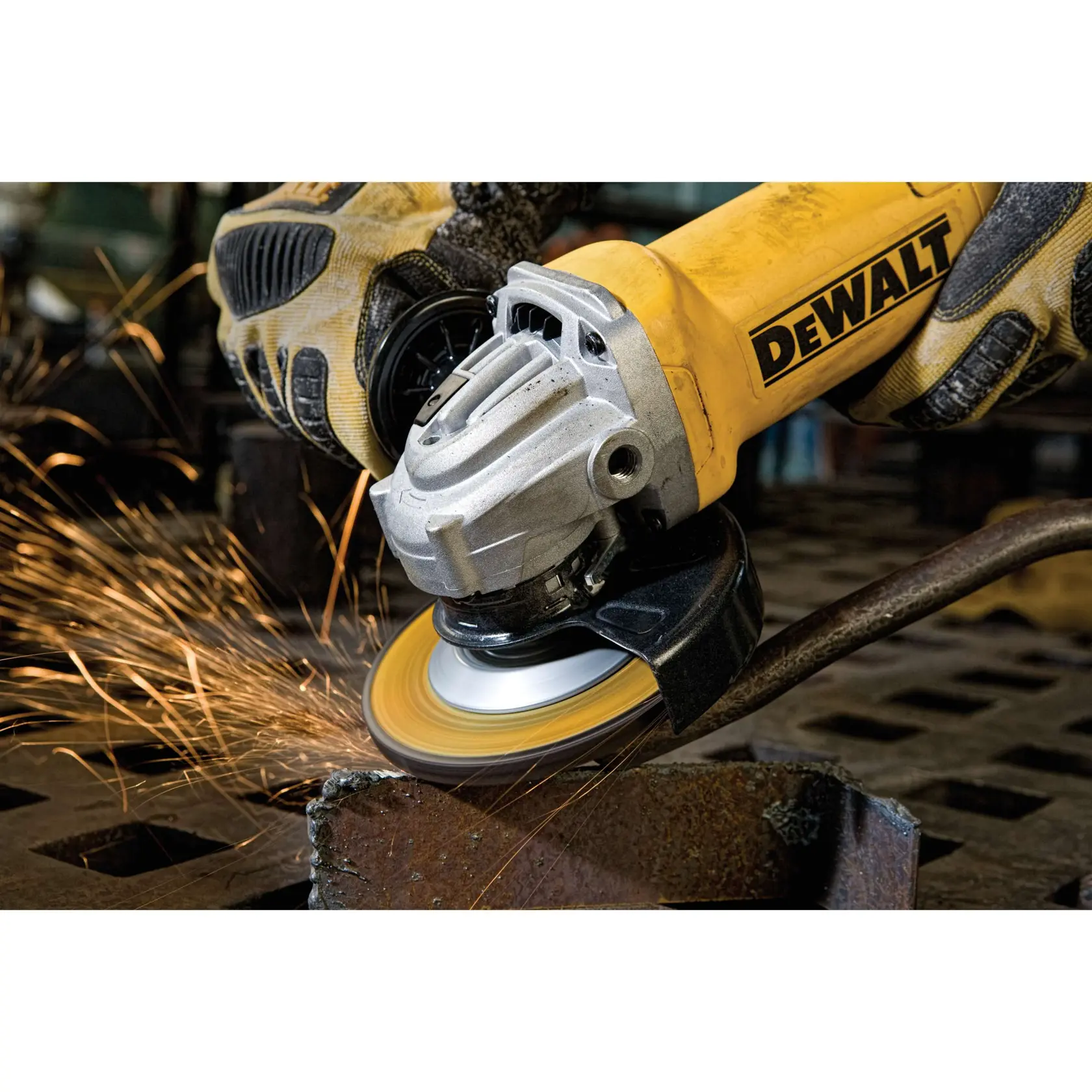 A close-up view of a Dewalt angle grinder in use, producing sparks as it grinds metal. The person operating the tool is wearing protective gloves.