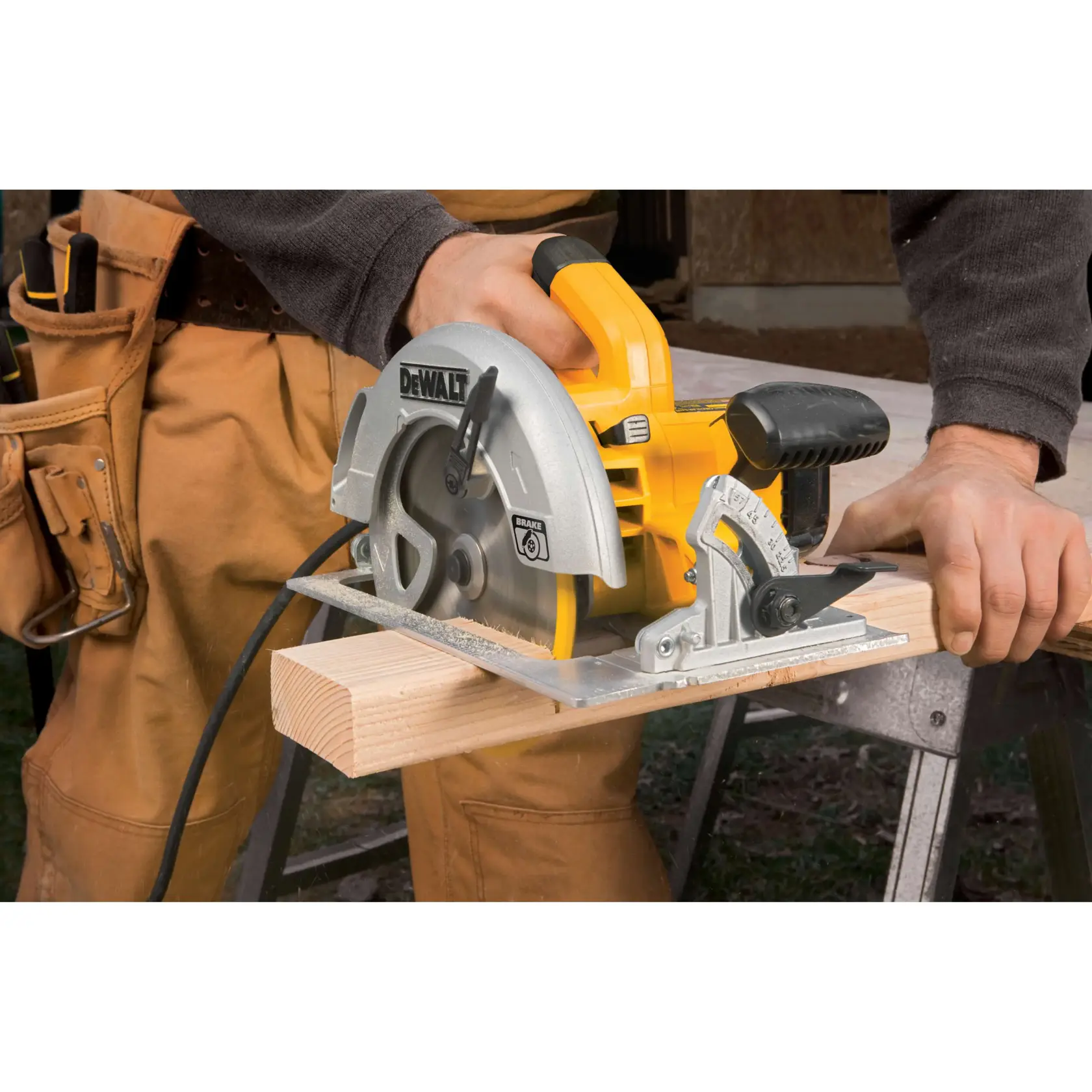 Image of a DEWALT DWE575SB tool kit, including a yellow and black contractor bag and a lightweight circular saw with a 7-1/4 inch carbide-tipped blade. The kit also includes a blade wrench and a user instruction manual.