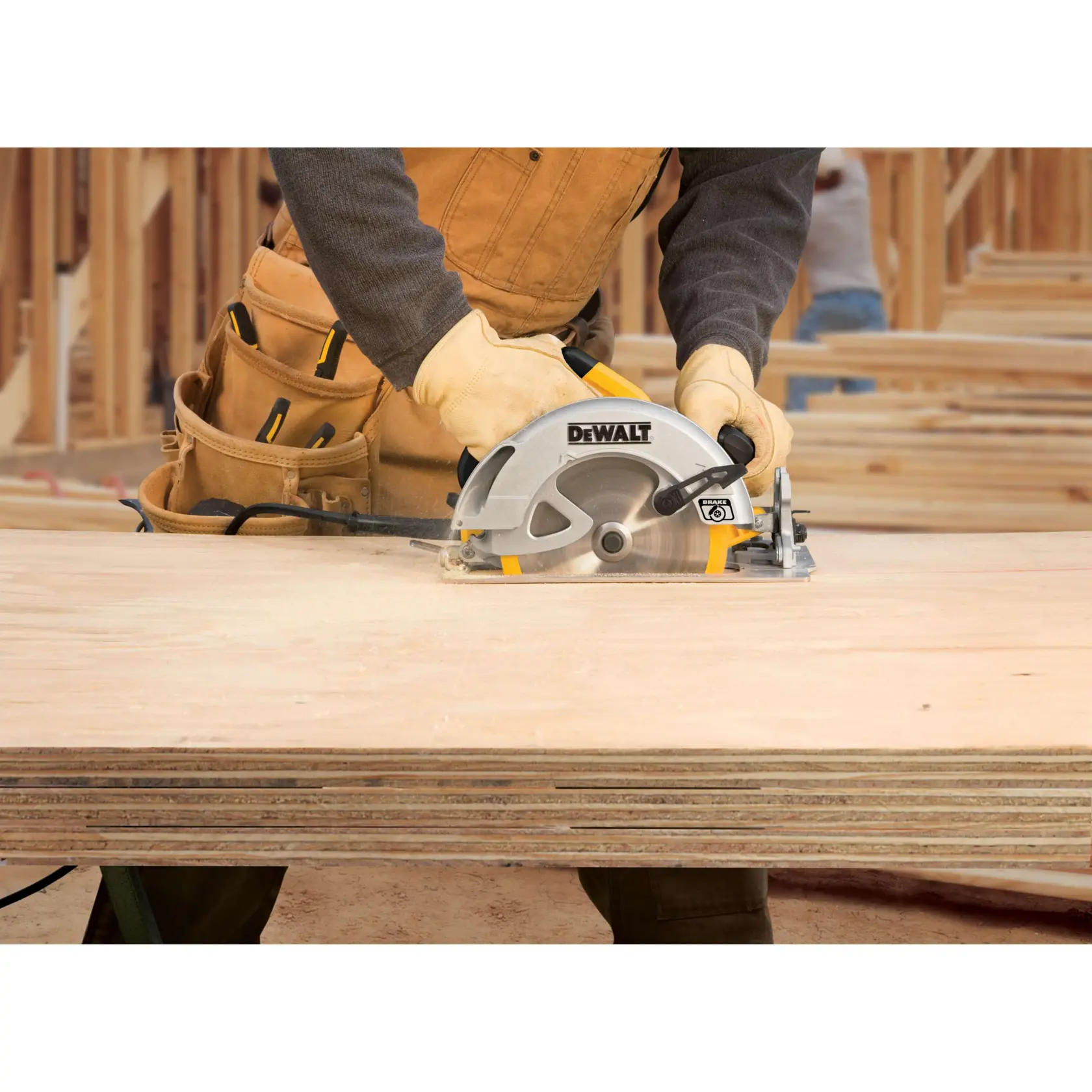 A person using a DEWALT circular saw to cut a piece of wood on a sawhorse outdoors. The saw is yellow and silver in color and plugged into a power source.