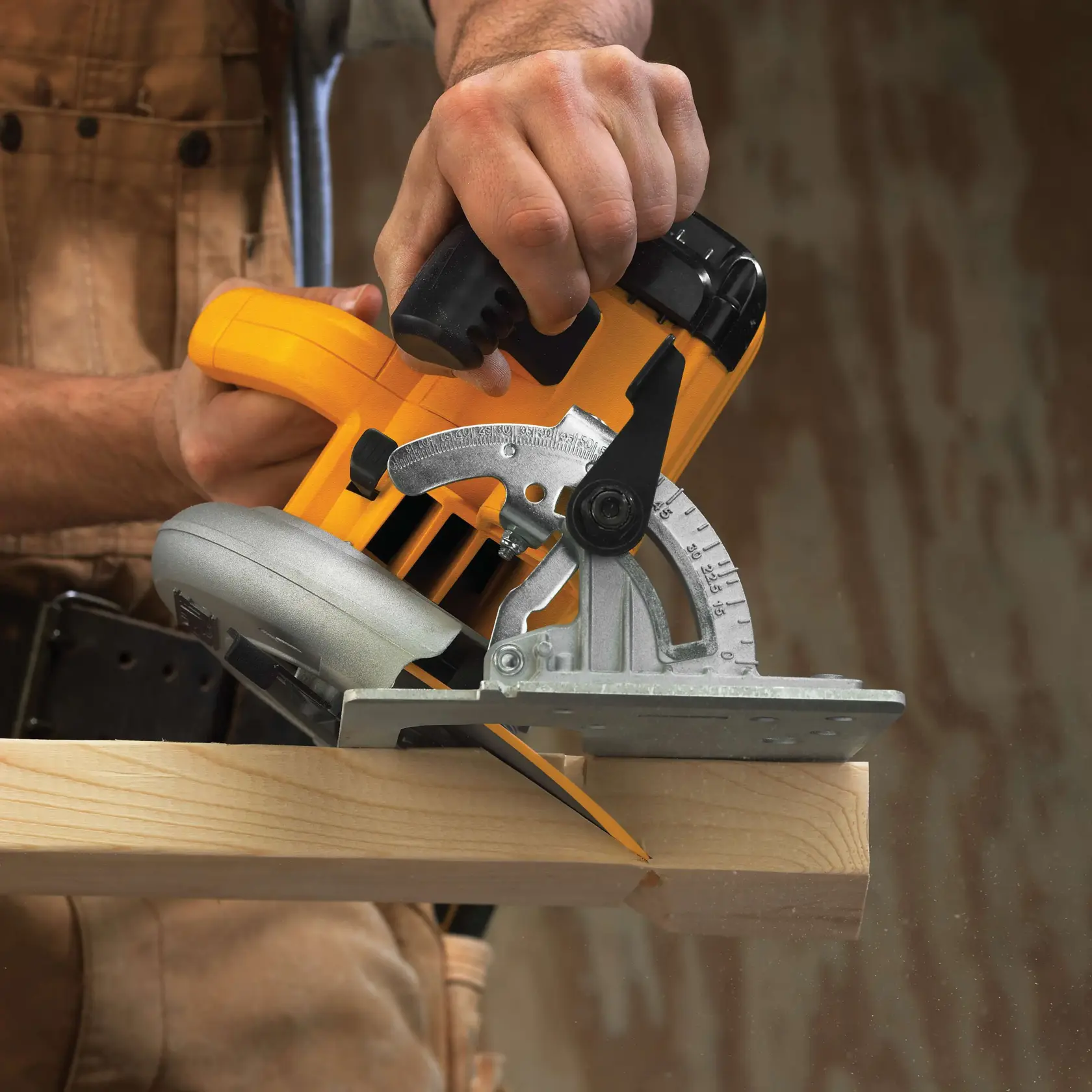 A close-up of a person using a yellow DEWALT circular saw to cut a wooden plank.