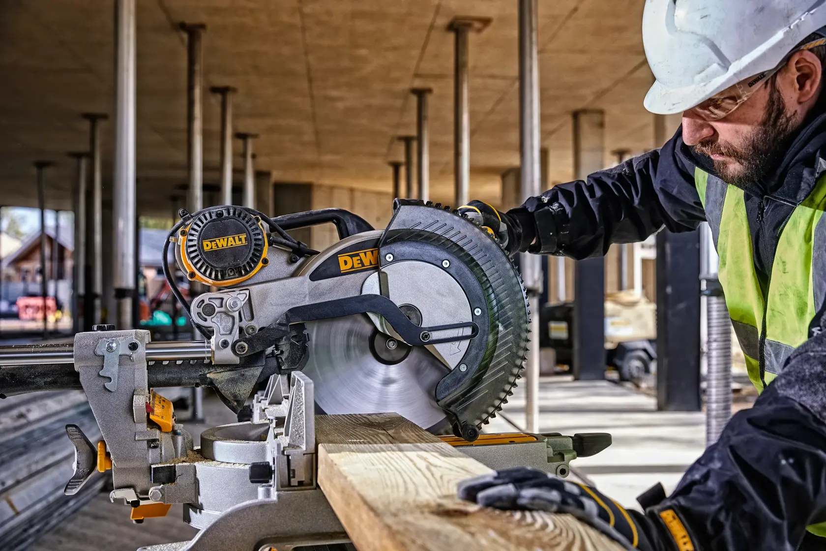 DEWALT DWS780, DWS780KIT miter saw in use at a building site. Worker cuts wood. Photography product category.