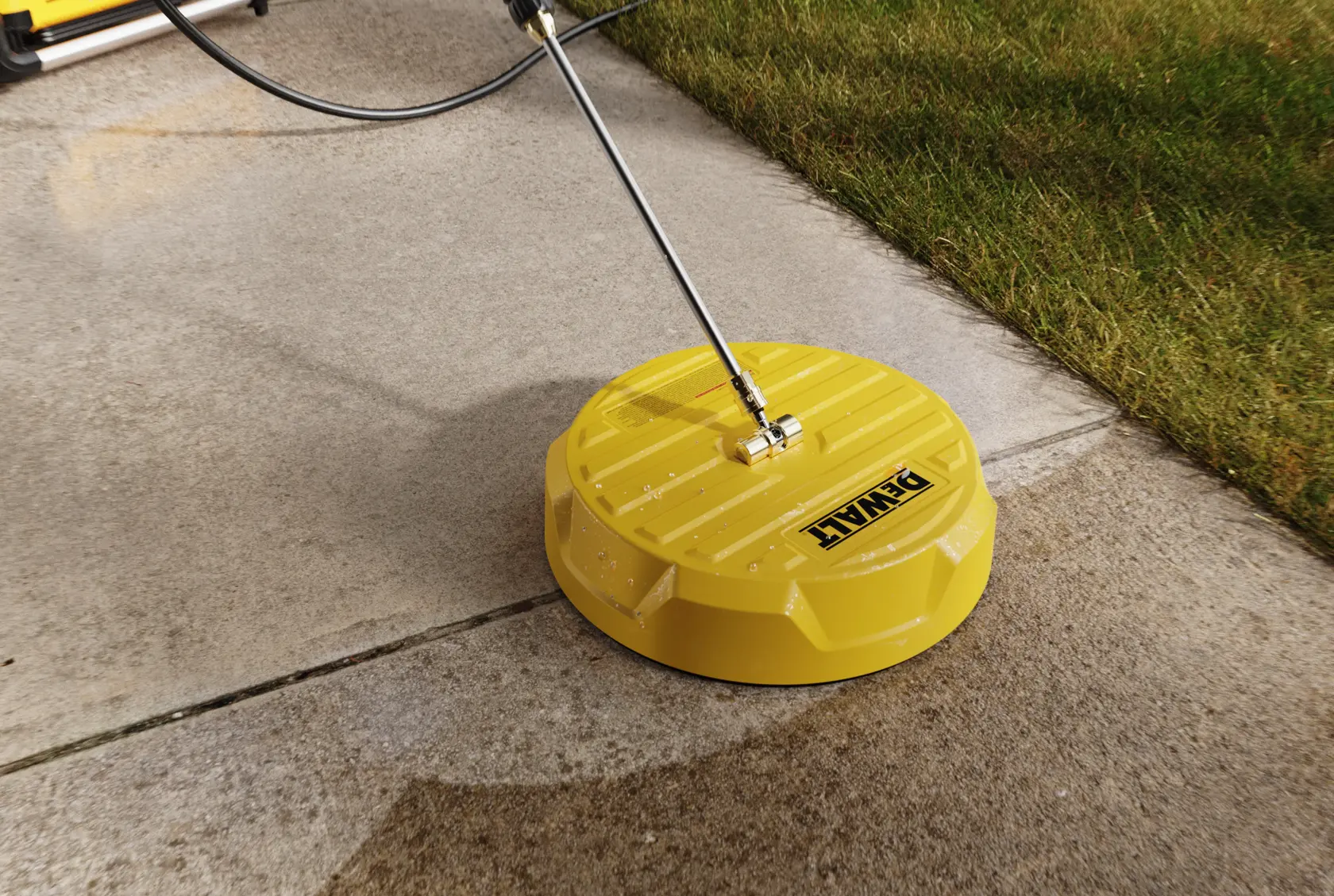 A yellow DEWALT surface cleaner is being used to clean a concrete sidewalk. The device is attached to a metal handle and is removing dirt, leaving the sidewalk visibly cleaner next to a patch of grass.
