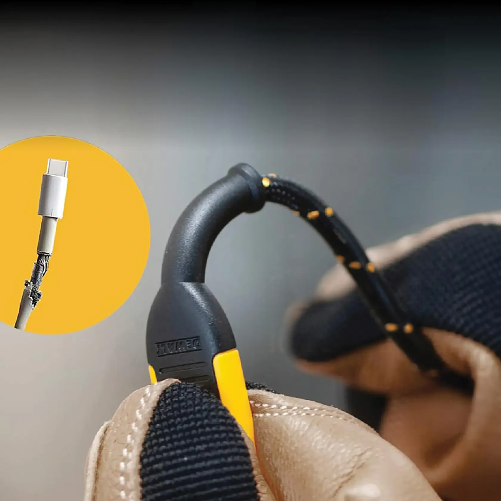 A close-up image of a DEWALT-branded cable with a reinforced protective sleeve, held by a gloved hand. An inset shows a damaged USB-C cable, highlighting the importance of cable protection.